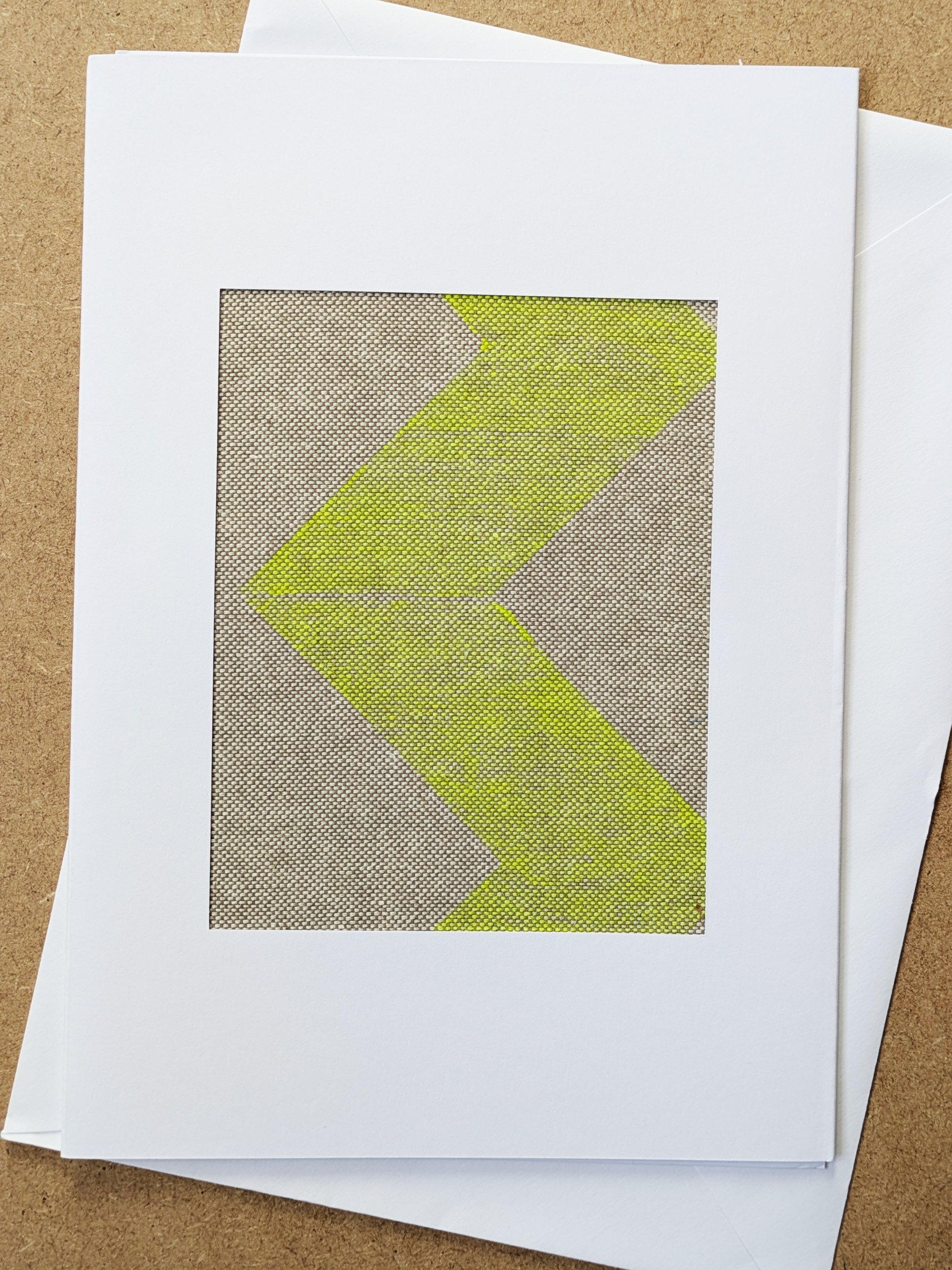 bright abstract neon yellow chevron print on fabric piece framed in white postcard frame and white envelope