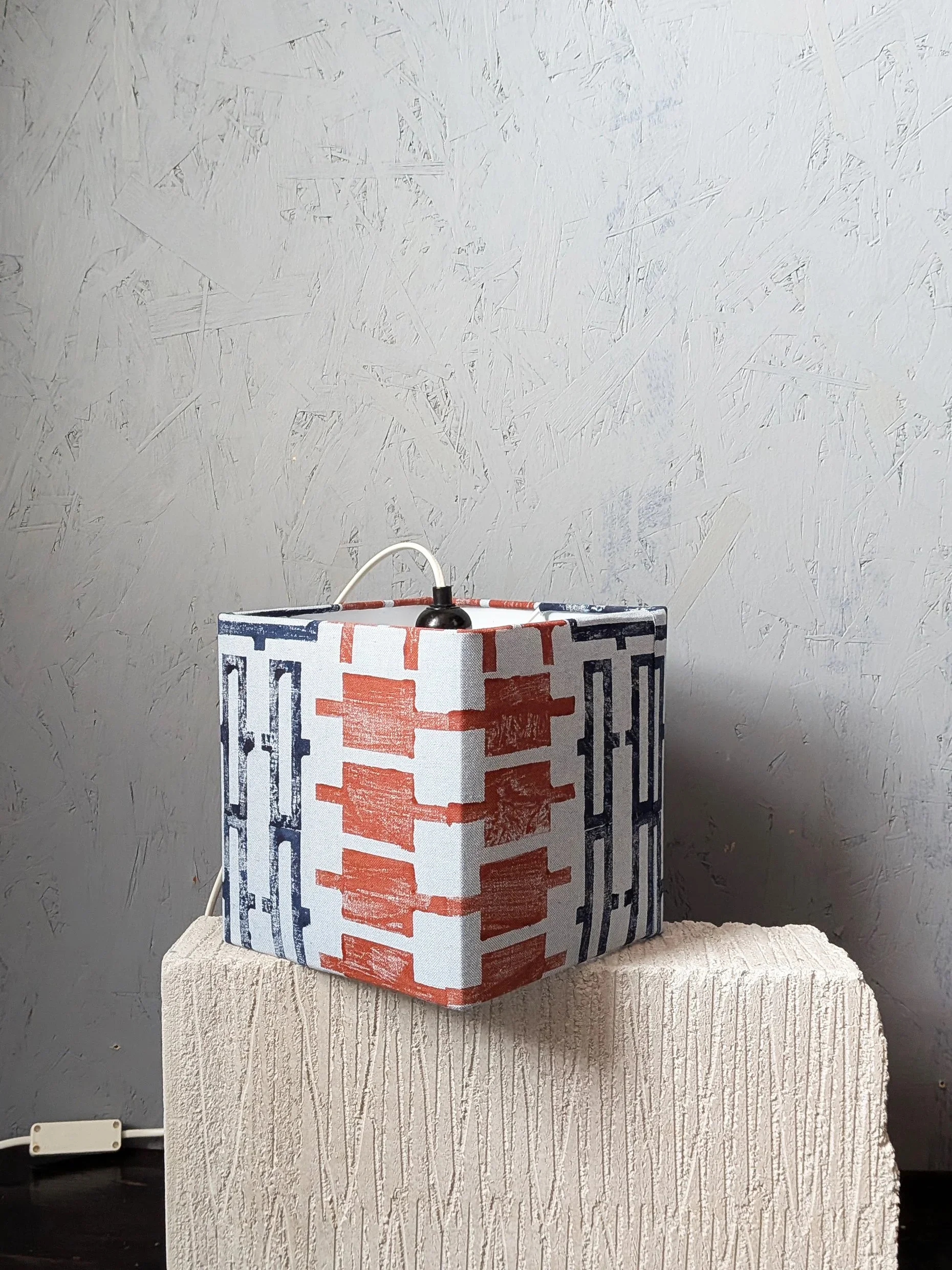 architecture inspired cubical lampshade in hand printed pattern minimalist studio scene