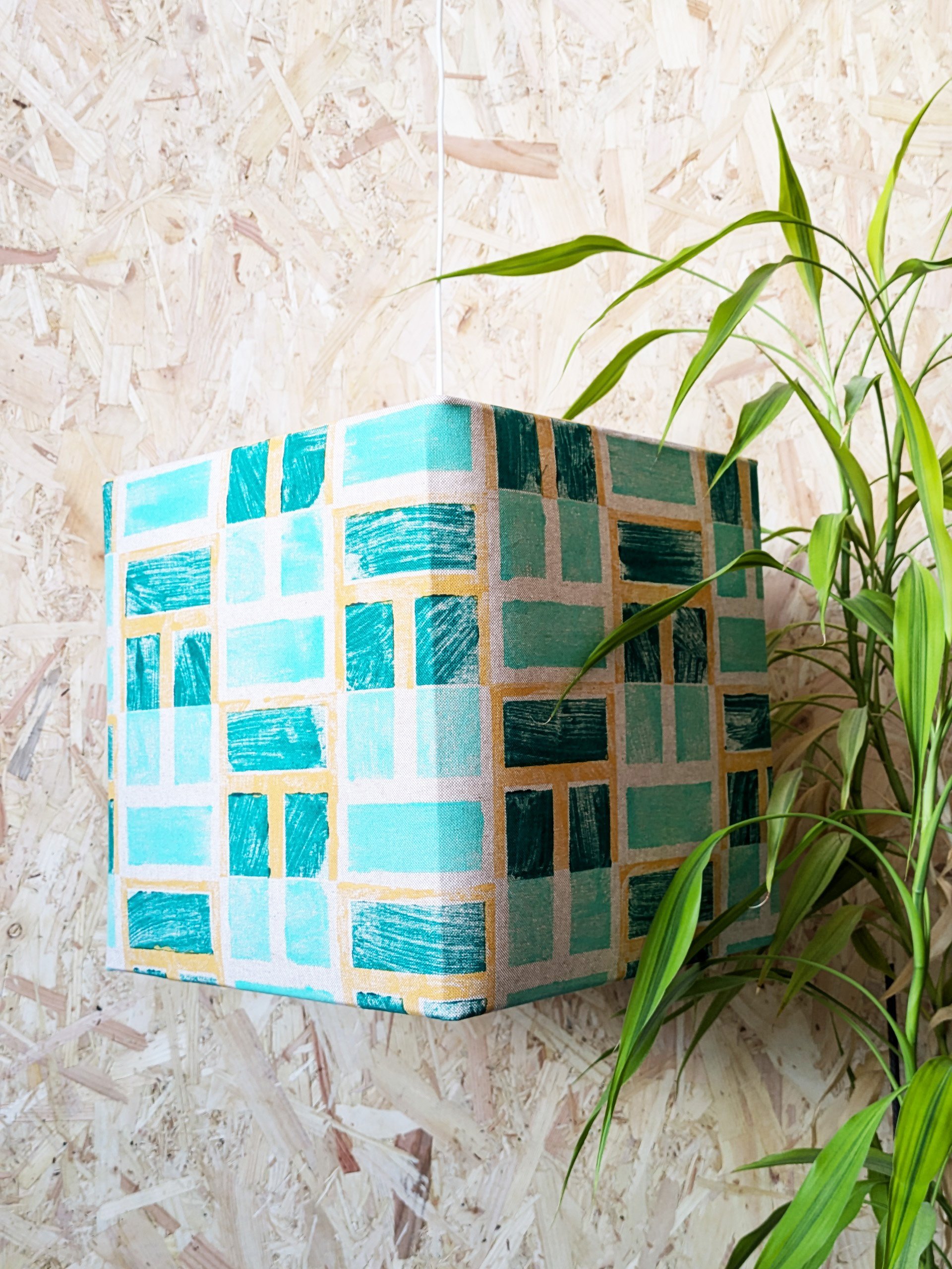geometric pattern on cubical lampshade in architectural inspired print and lush green colours