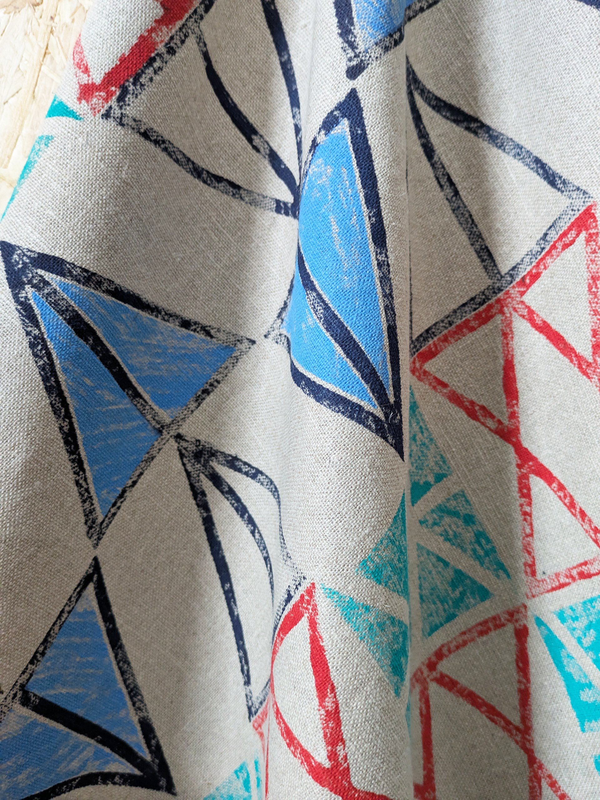 close-up details of hand block printed pattern on linen teatowel in graphic, geometric abstract pattern