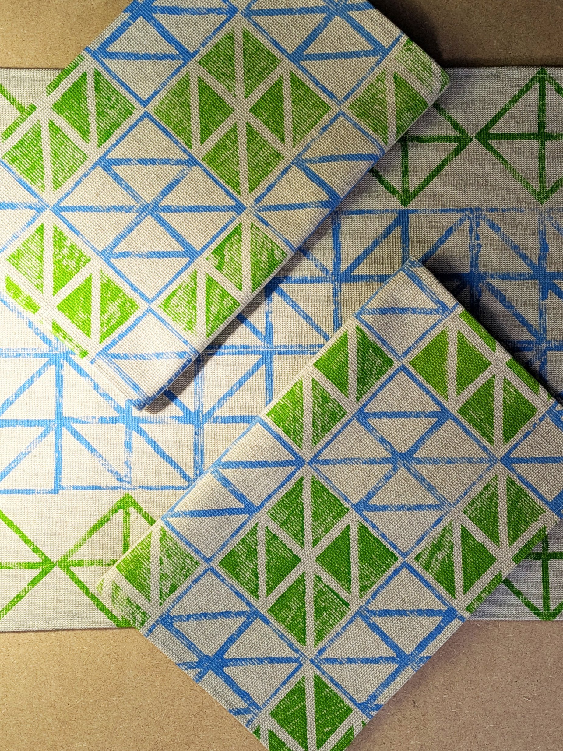 geometric triangular print place mats in neon green and blue
