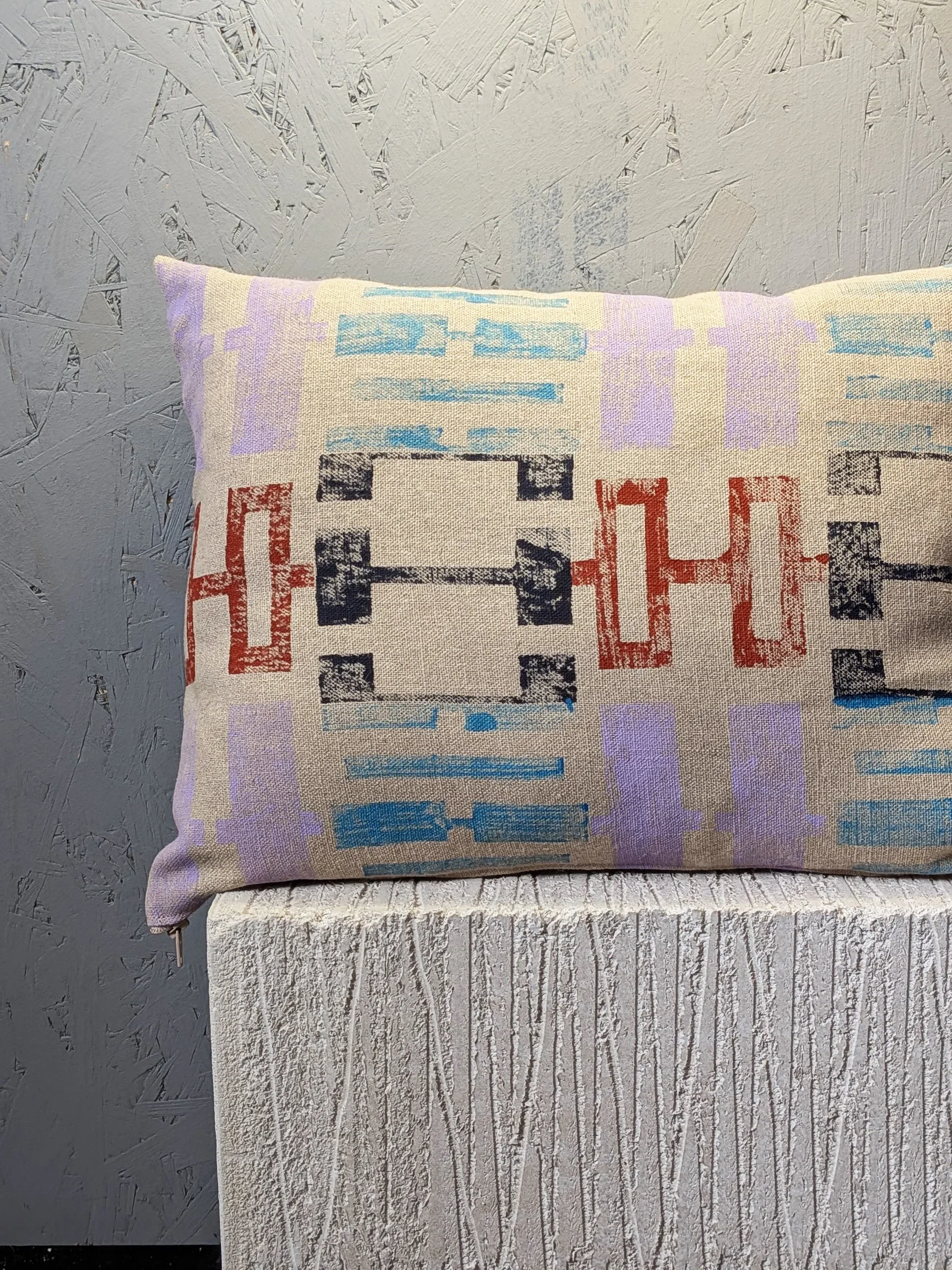 modern block printed geometric linen cushion in pastel and blue pattern