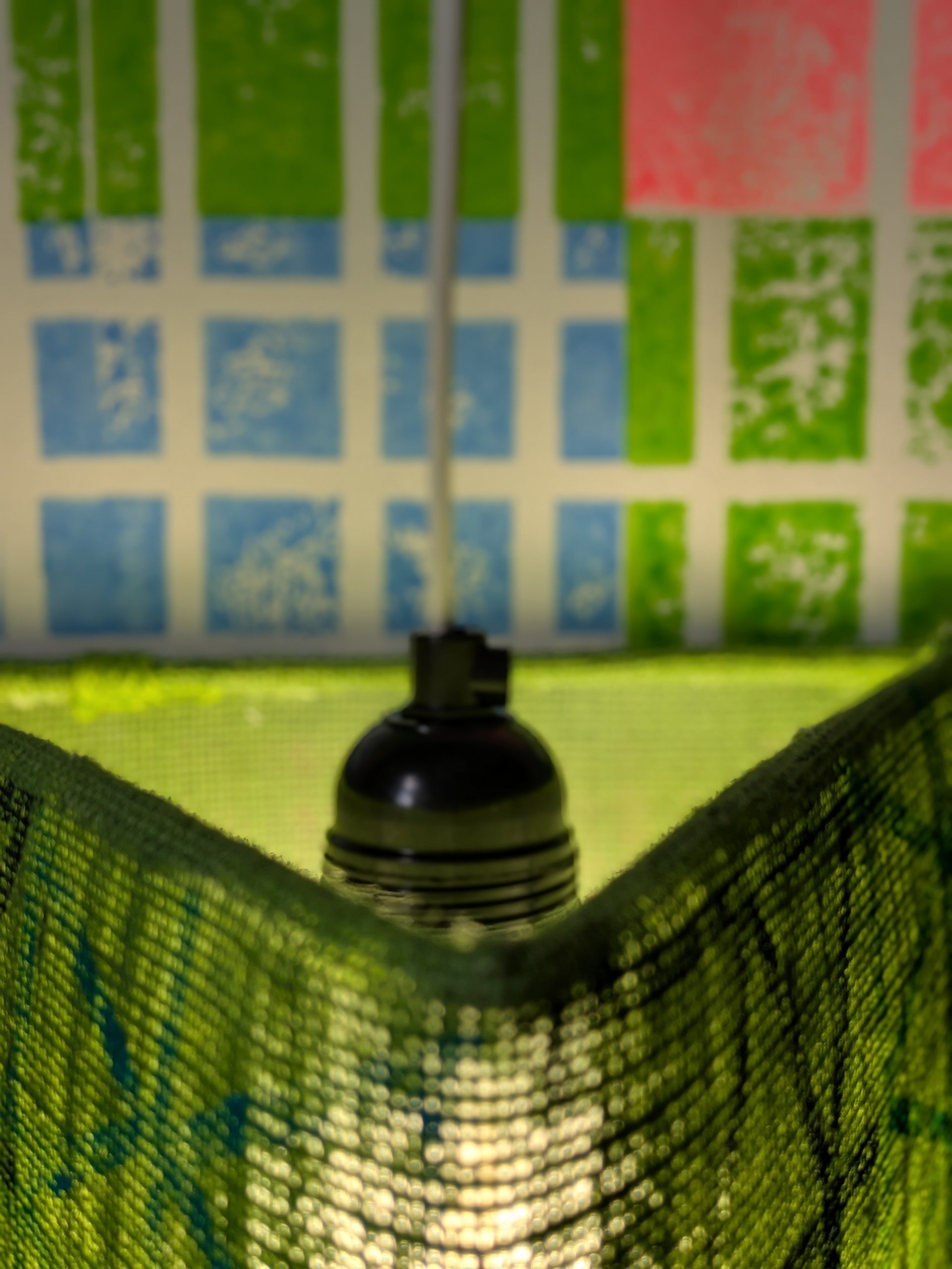 close-up detail of inside green triangular lampshade