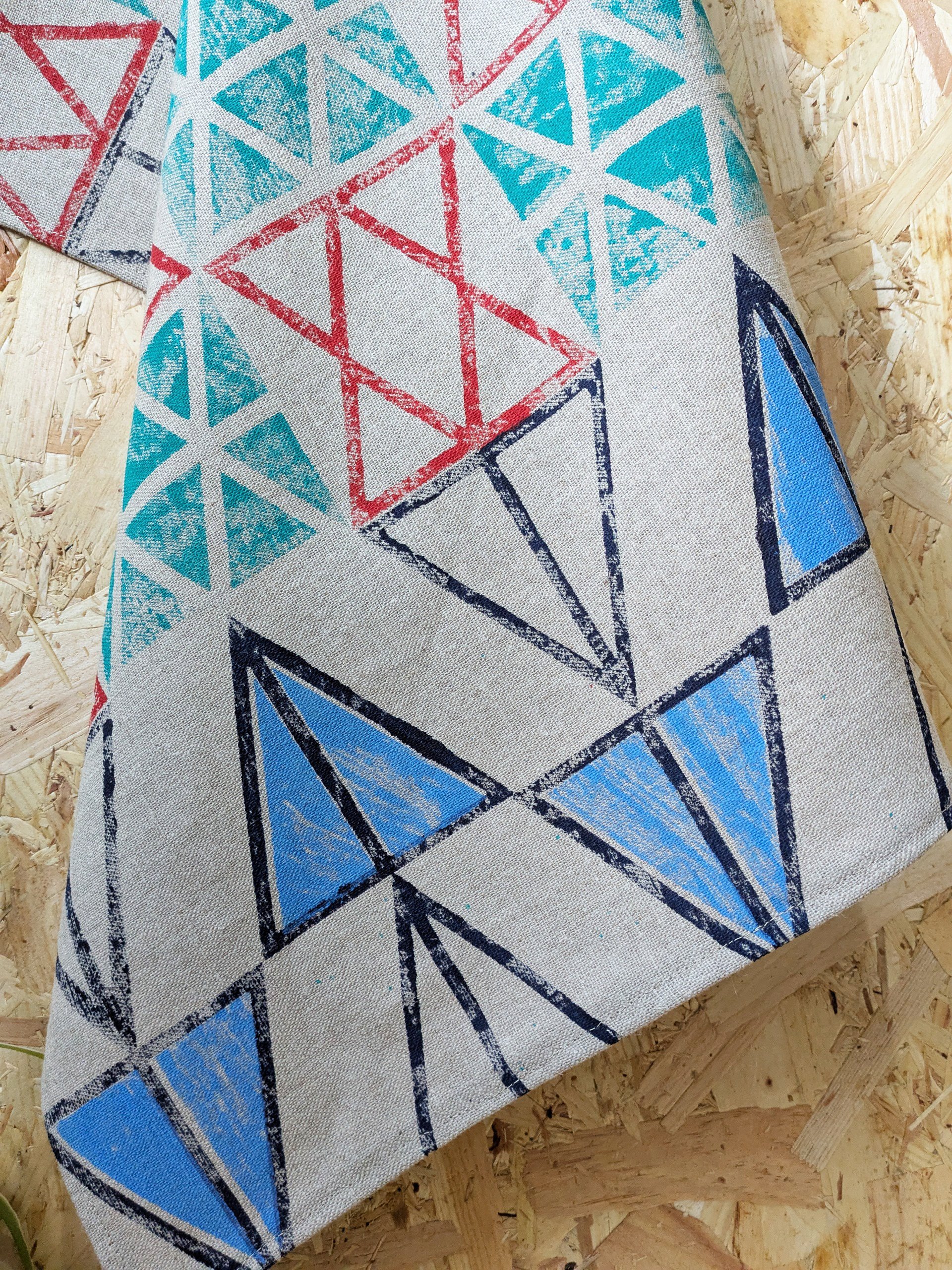 hand printed triangular pattern on linen kitchen towel in contemporary colours