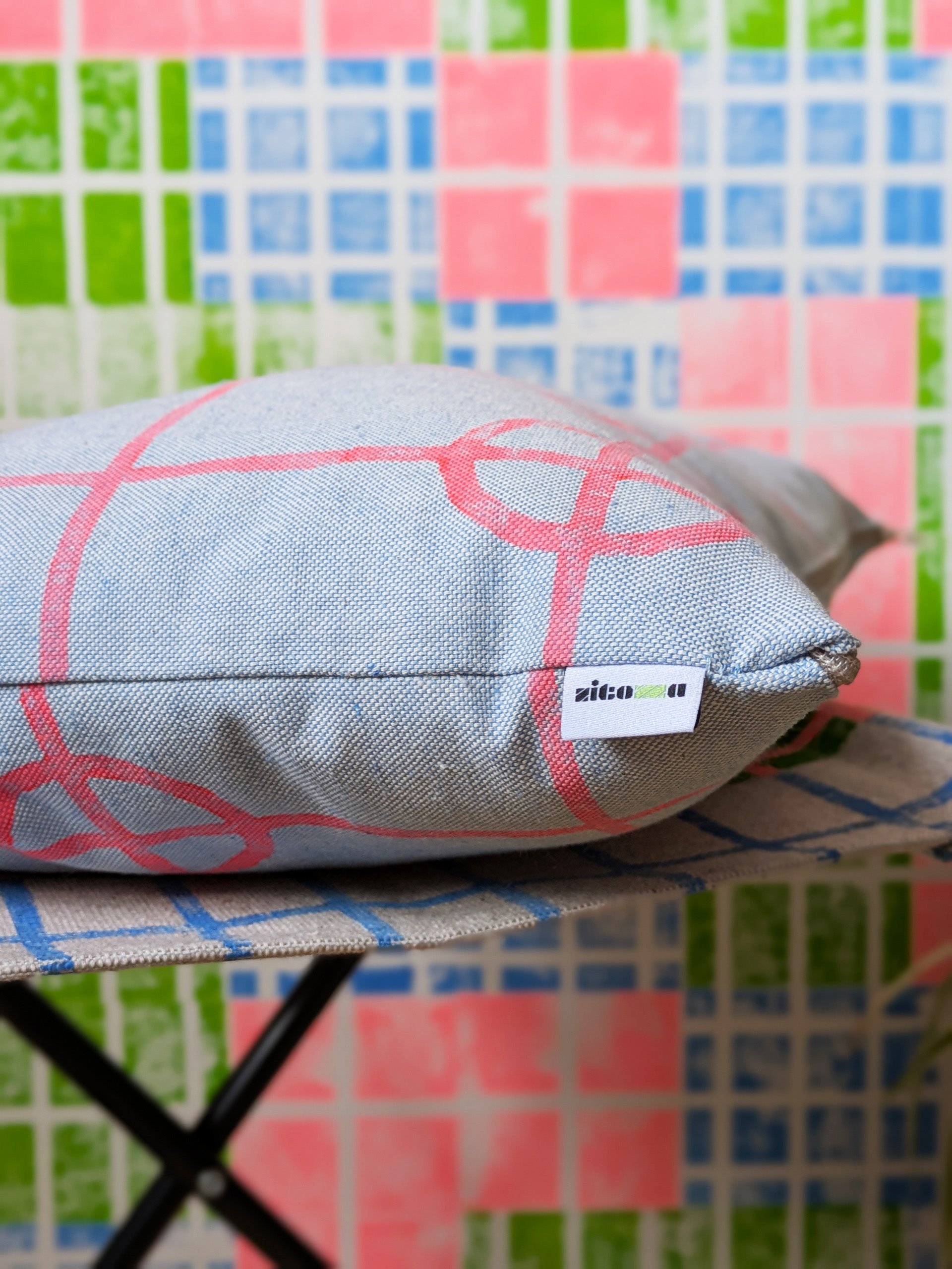 close-up detail of blue cushion with simple geometric grid print