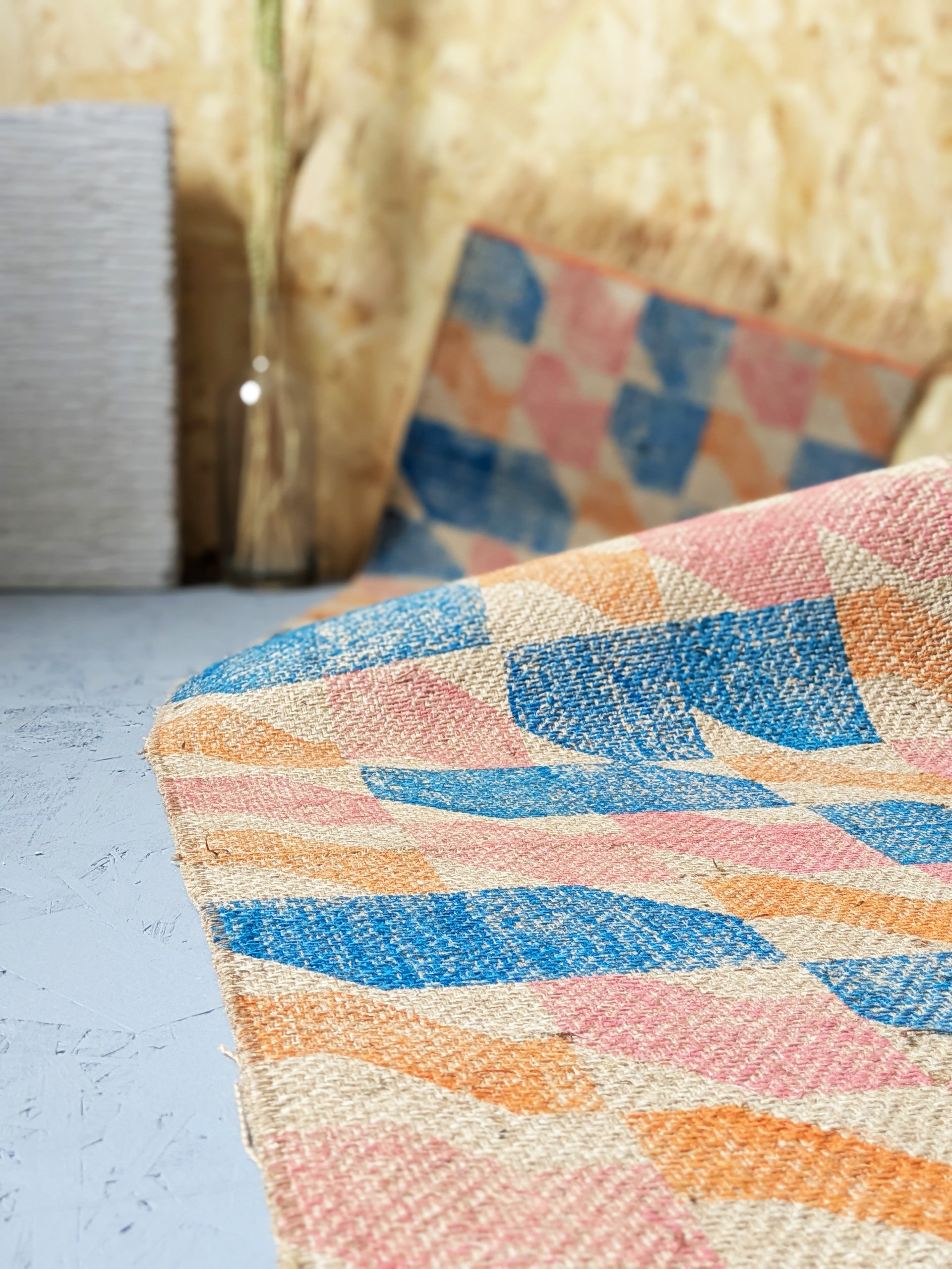close-up detail of texture of heavyweight jute rug in bold architecture inspired print