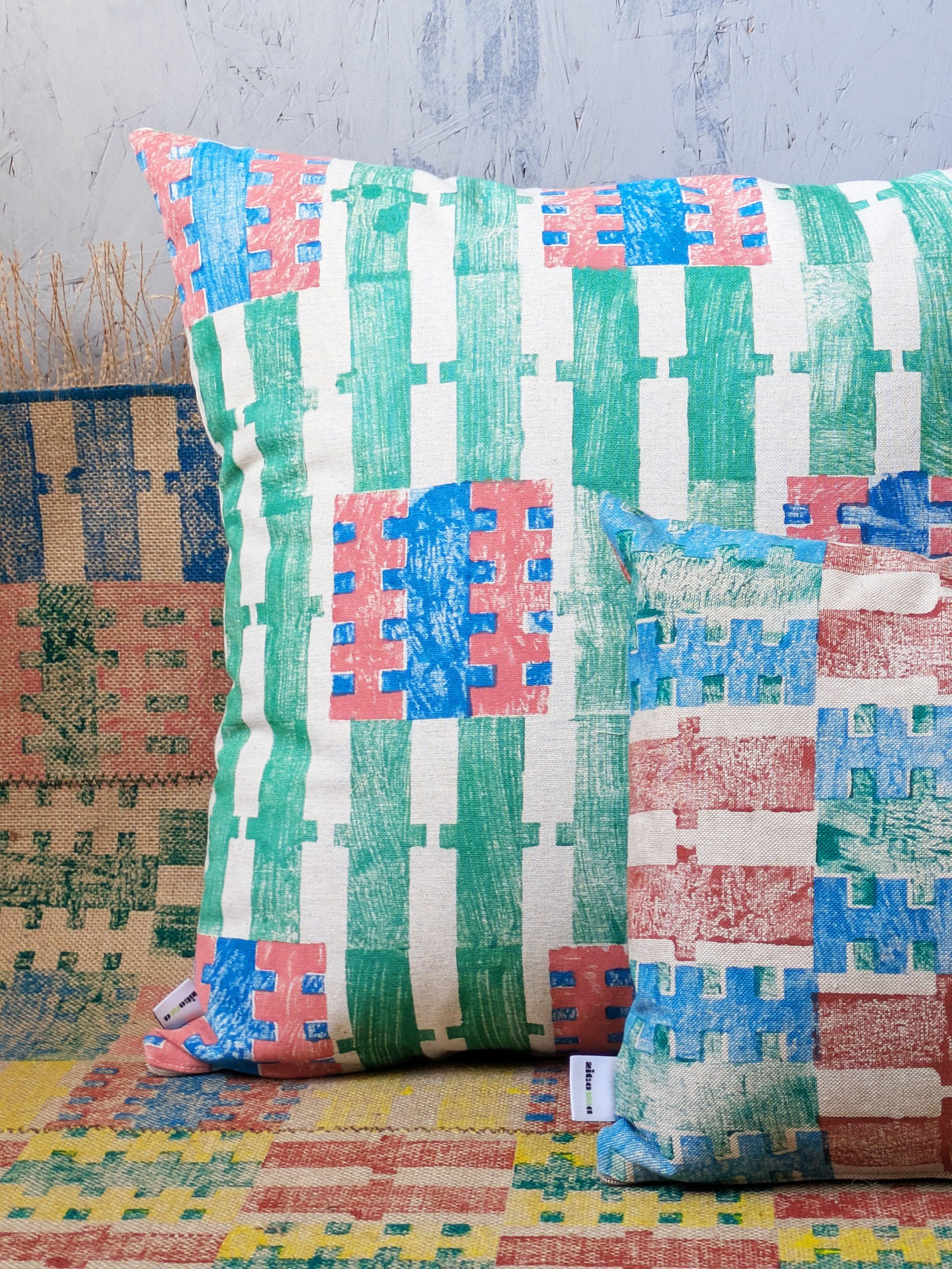 colourful scene with striped cushions in summer stripe patterns hand block printed on tactile fabrics