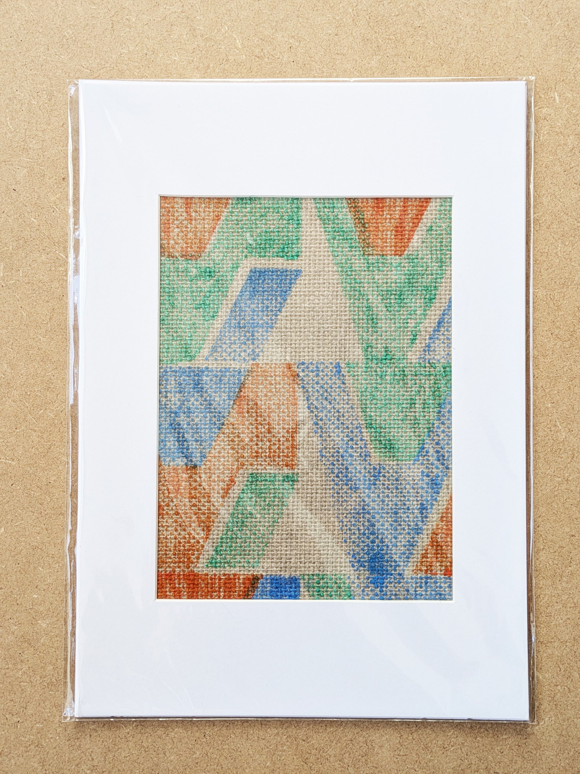 colourful, turquoise geometric architectural print on grasscloth, framed in white mountboard in A4