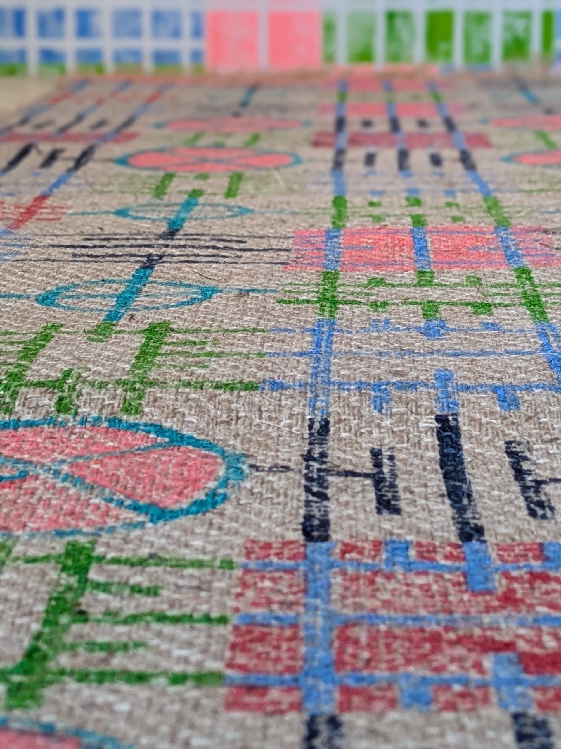 detail of tactile jute texture on hand block printed rug with architectural pattern