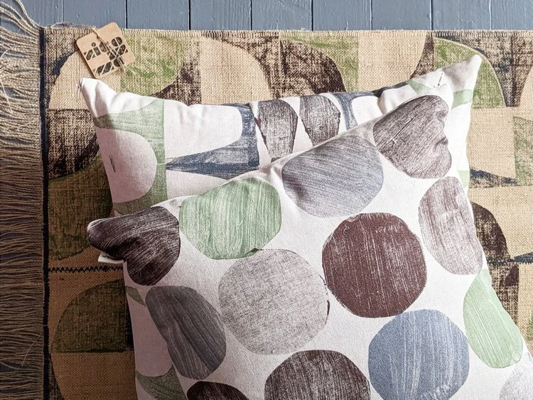 hand printed cushions on rug in modern abstract printed style