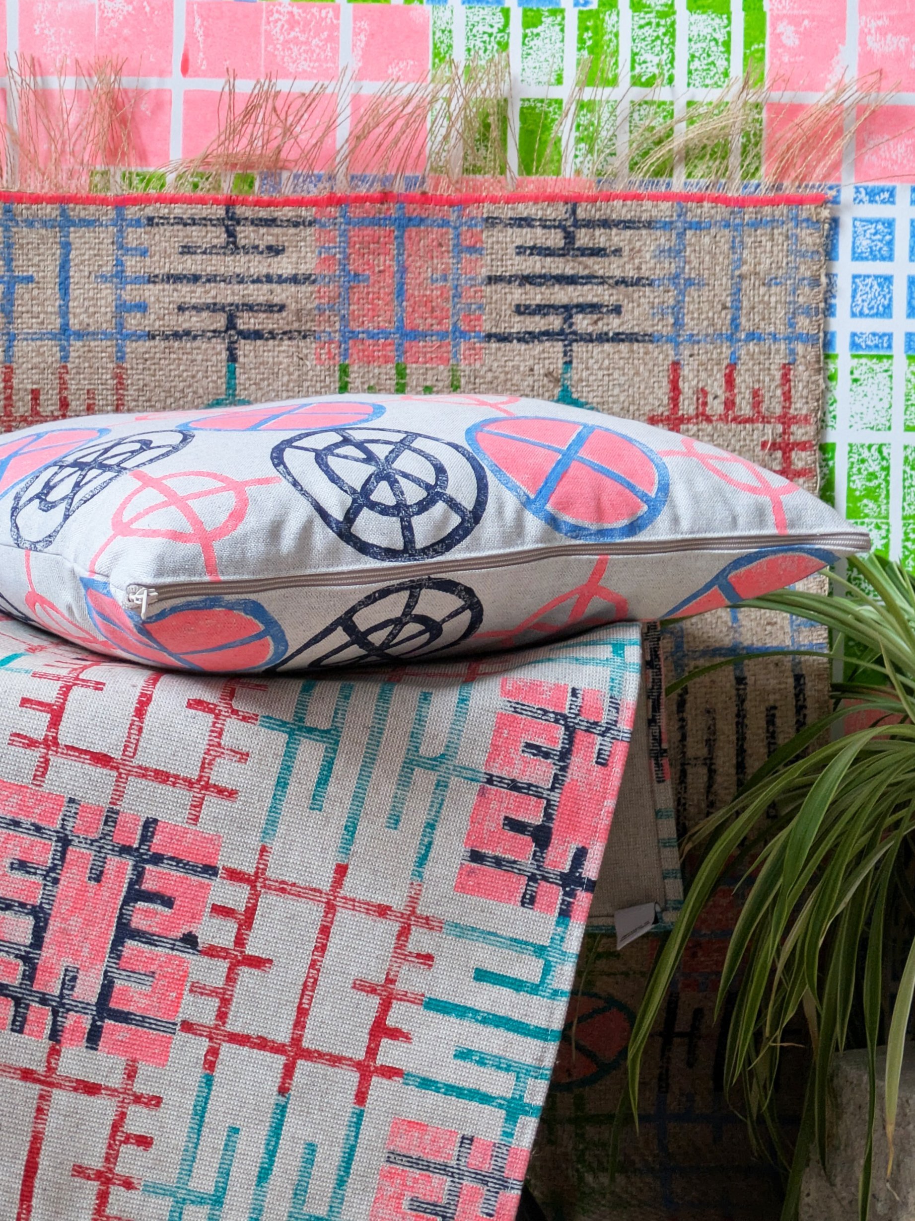 cosy studio scene with bright block printed textiles and cushion in circular neon print