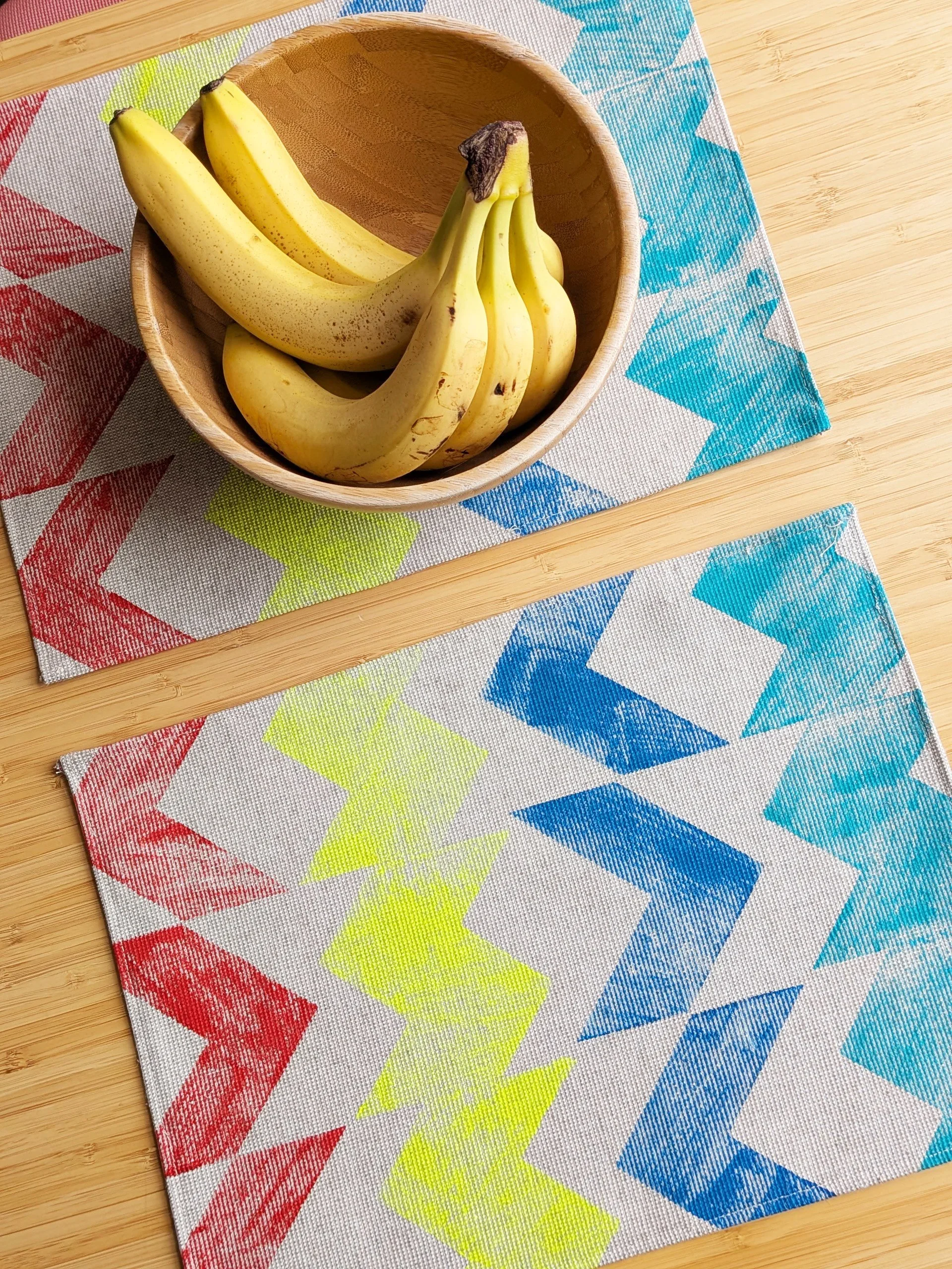kitchen table with hand block printed zig-zag striped colourful vibrant geometric place mats and fruit bowl