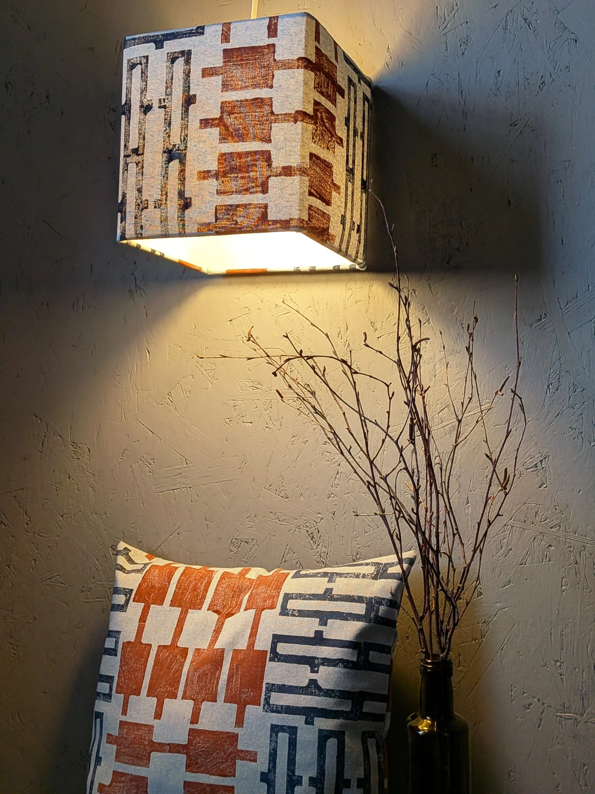 interior scene with cushion and lamp in blue, geometric, hand block printed textiles