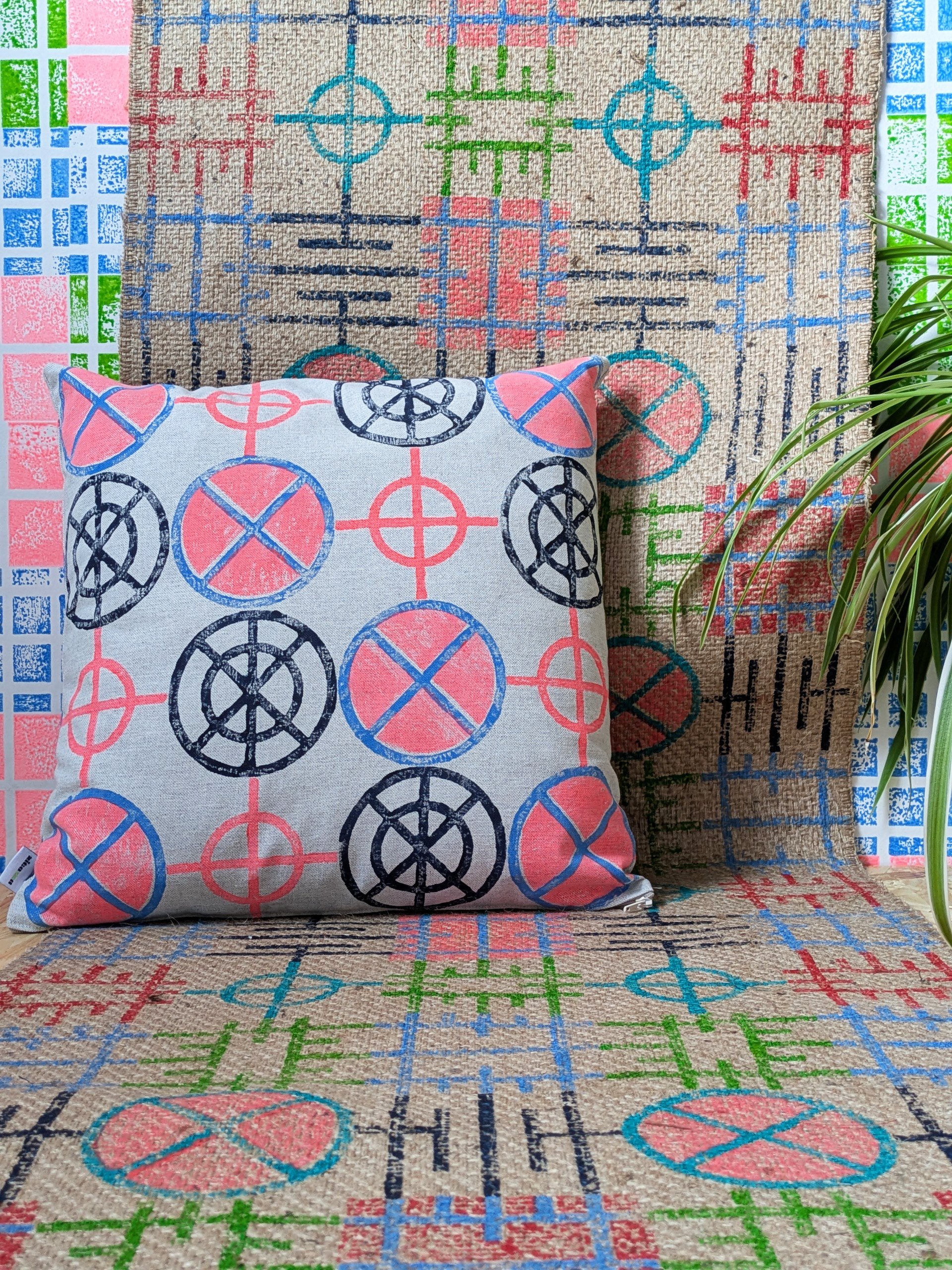 cosy and colourful interior decor scene with tactile jute rug and cushion with geometric graphic print in neon colours