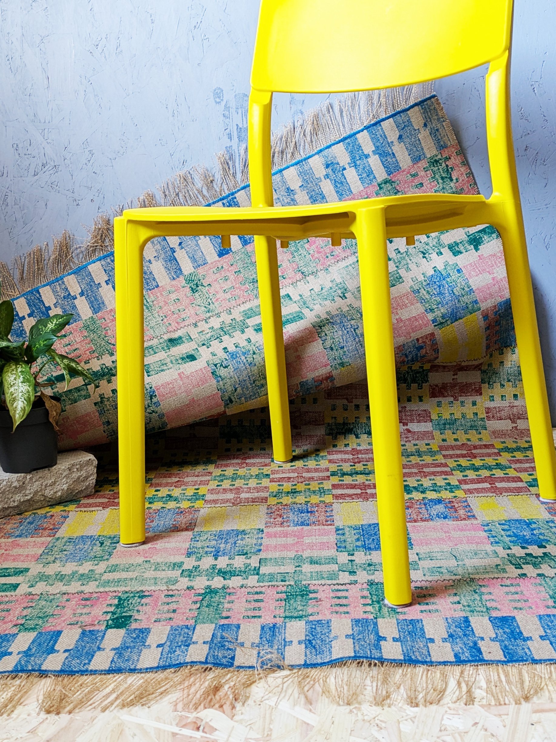 studio scene with fun yellow chair on bold striped and checked hand block printed rug