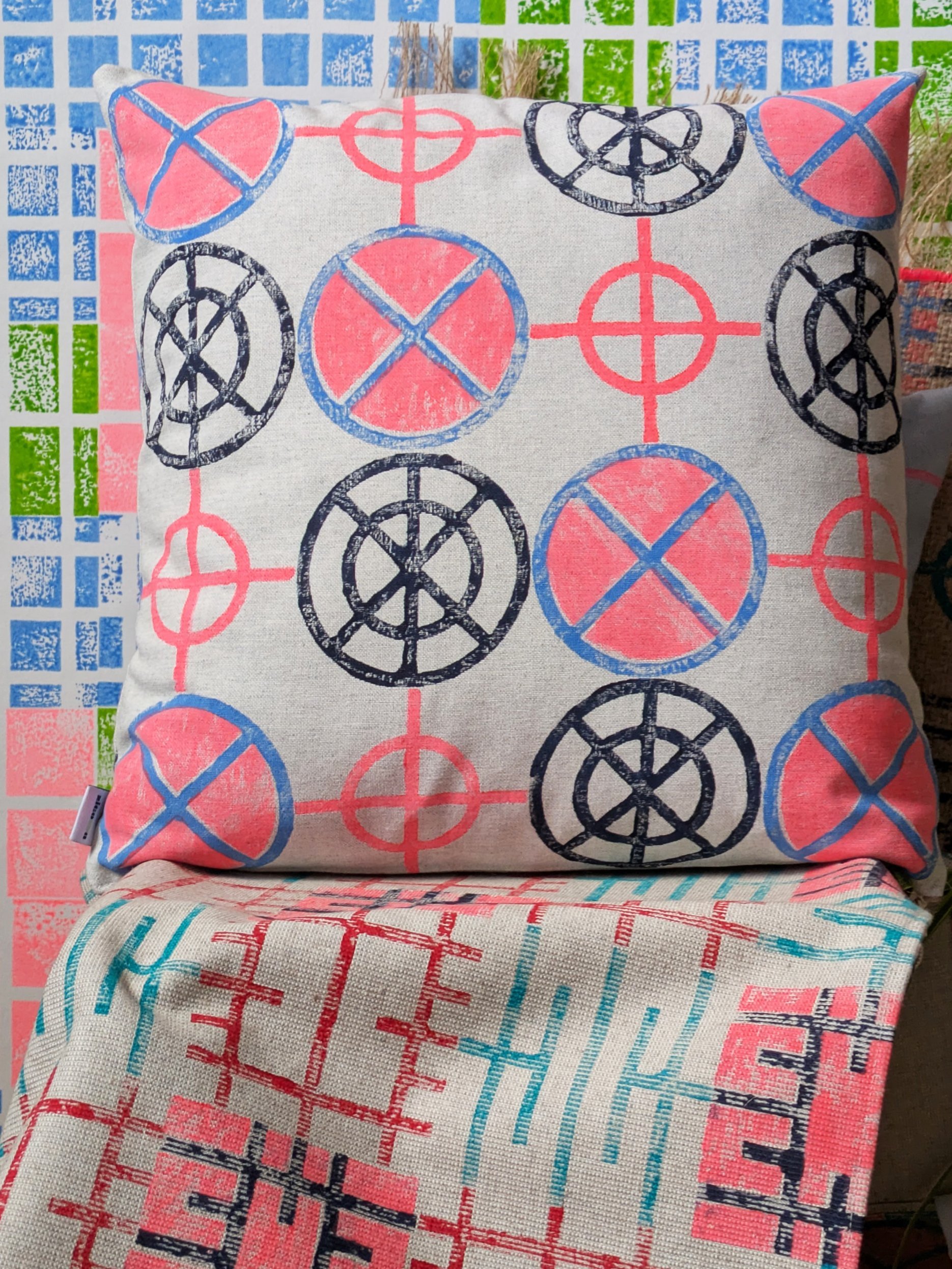 bright bold cushion with strong graphic pattern in abstract geometric circular shapes and neon colours
