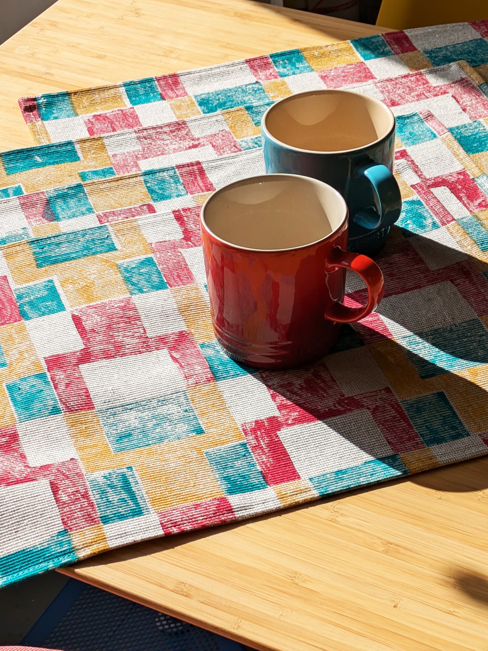 kitchen table with four place mats in retro inspired abstract geometric bold pattern design in contrasting colours