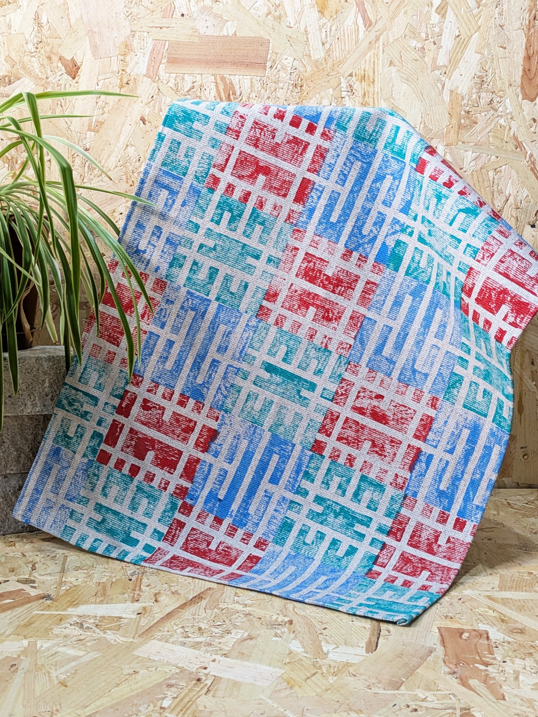 modern block printed teatowel in cold colours with touch of red