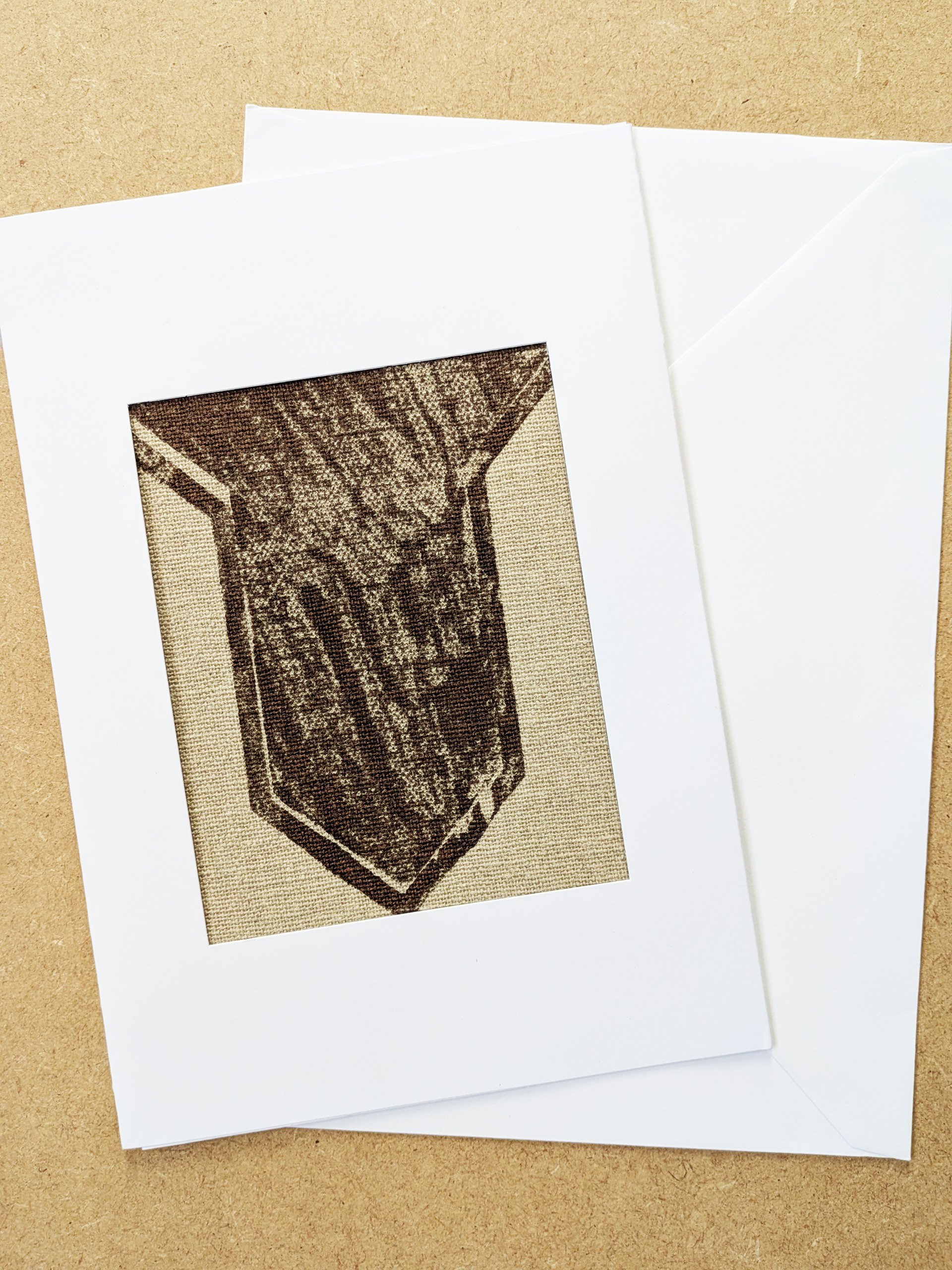 modern abstract textile print in brown colour framed in white postcard frame and white envelope