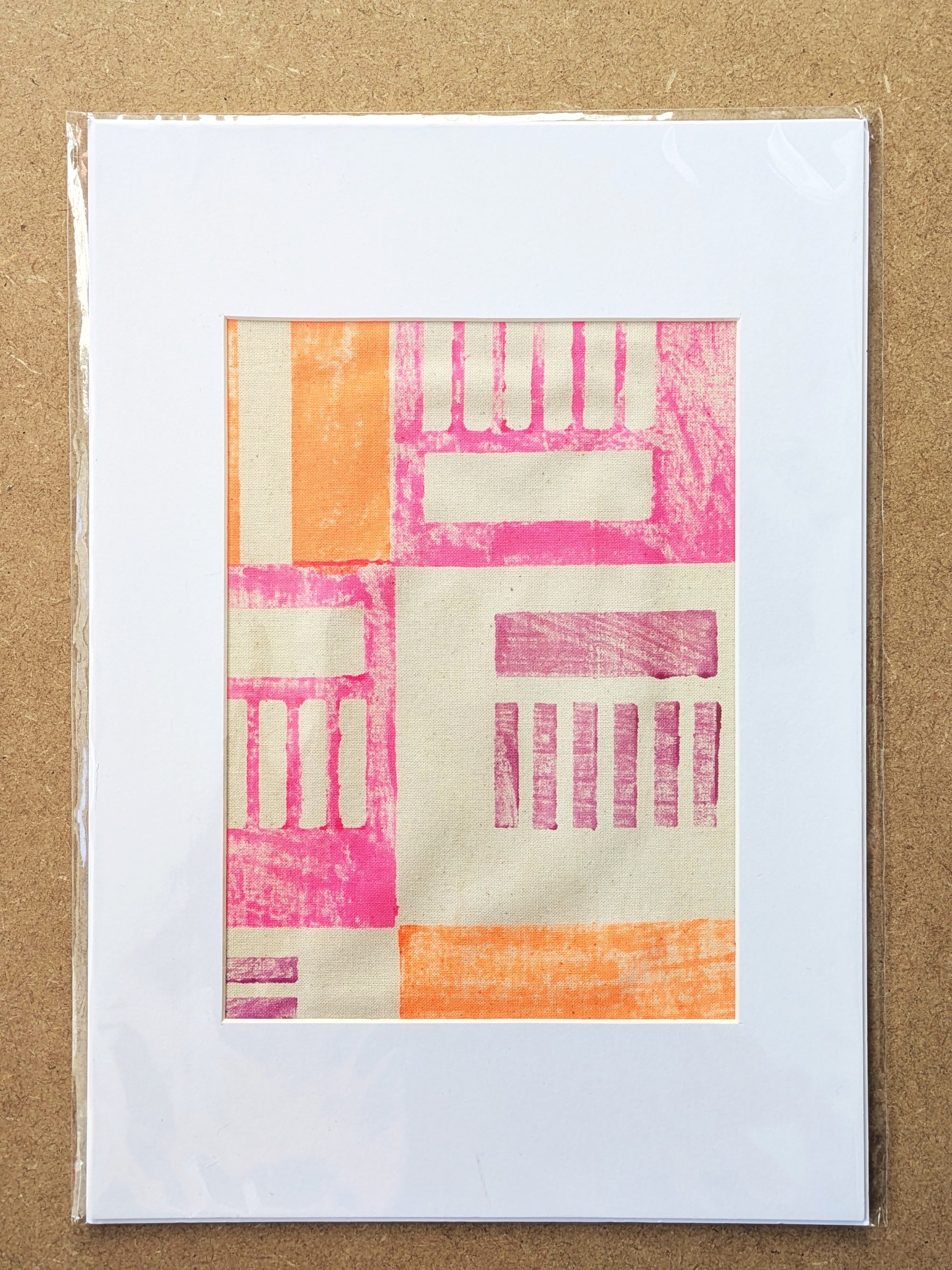 A4 fabric print with architecture inspired modern pattern in neon colours hand block-printed on cotton fabric and framed in white mountboard