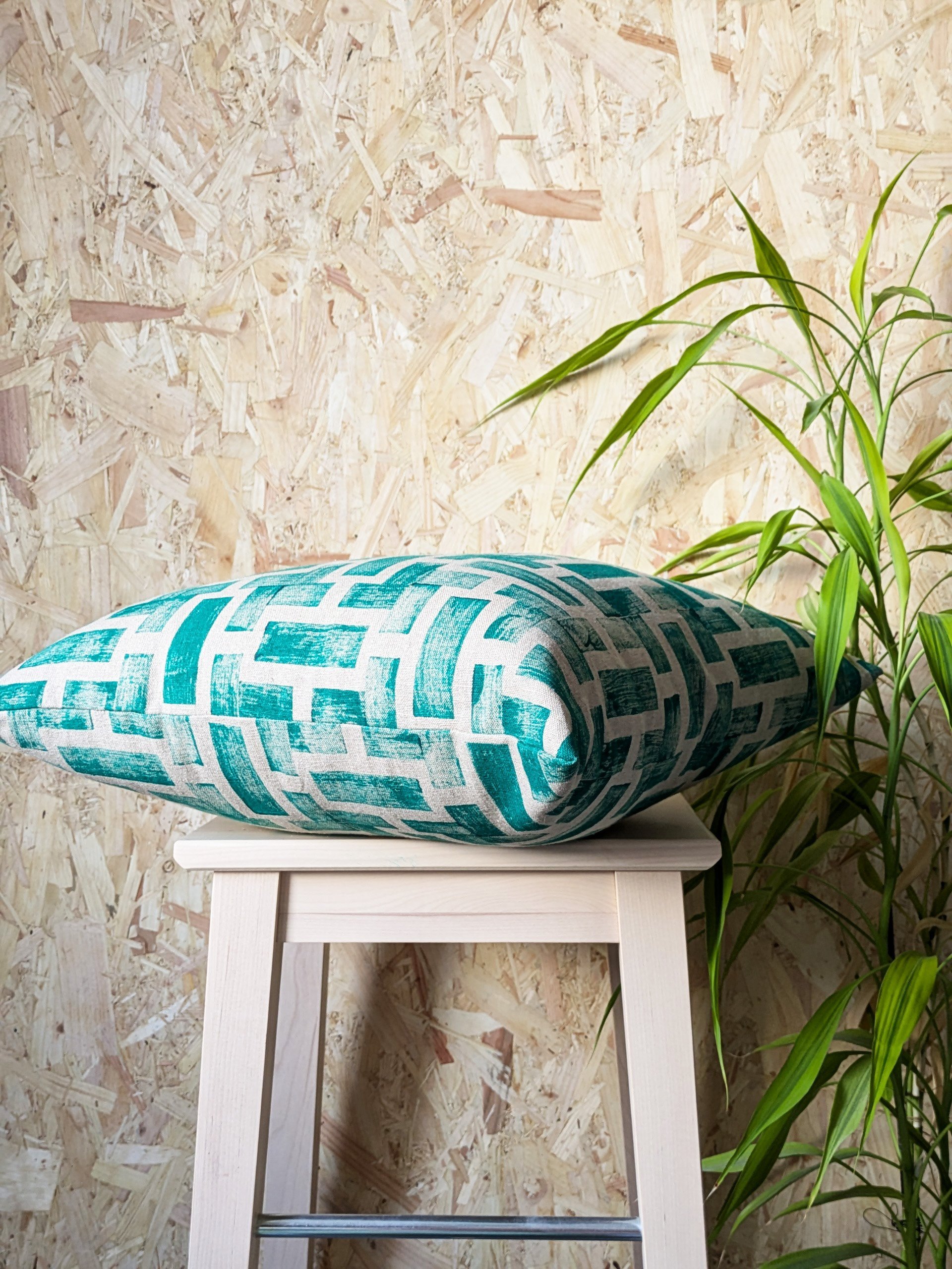 square cushion in dark green architecture inspired geometric print