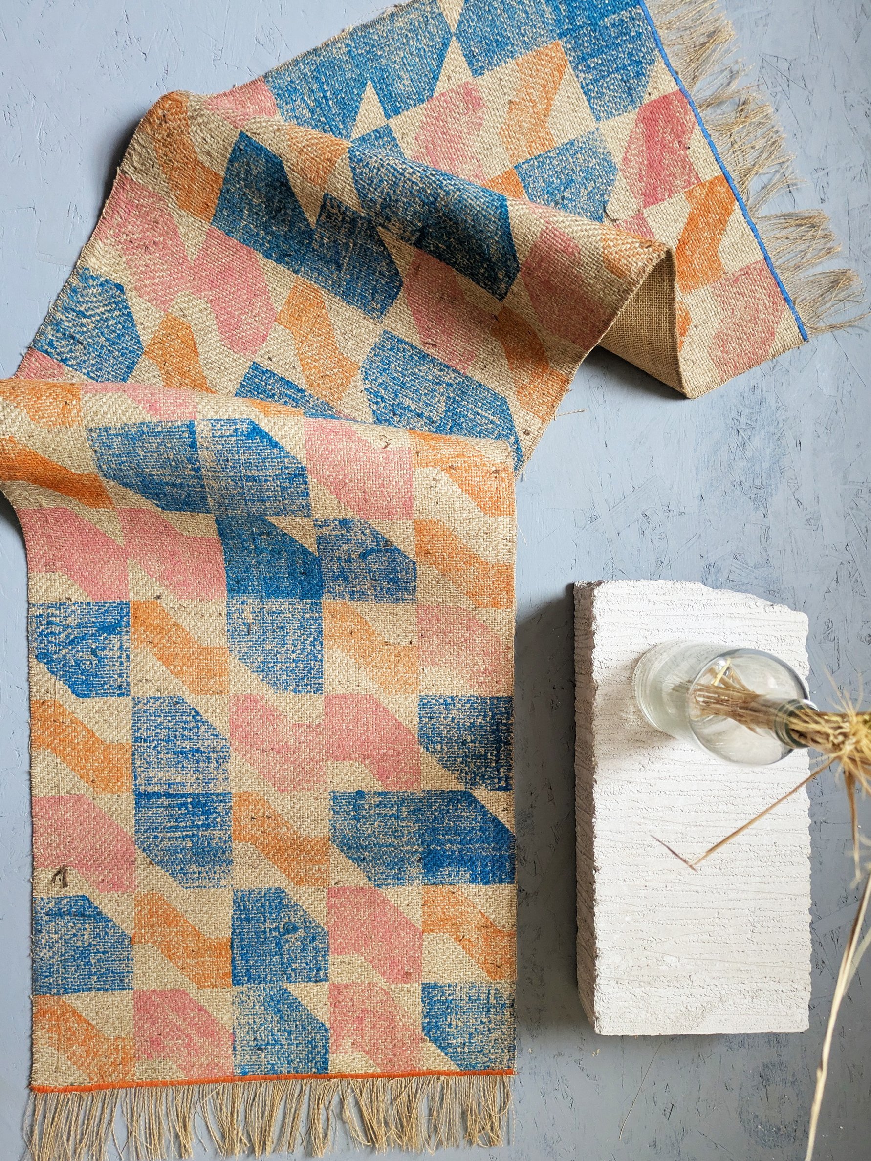 bold printed rug in staicase-inspired geometric block printed pattern and contemporary colours