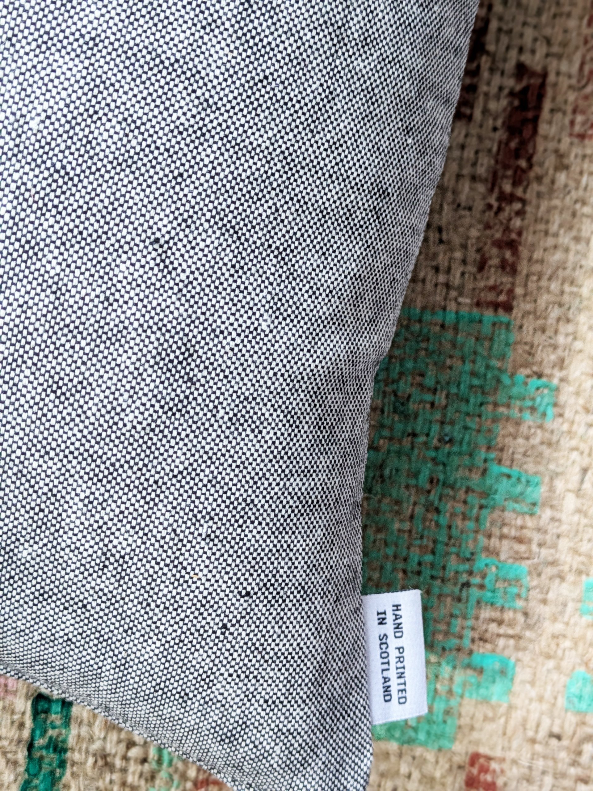 close-up detail of plan fabric texture on back of cushion