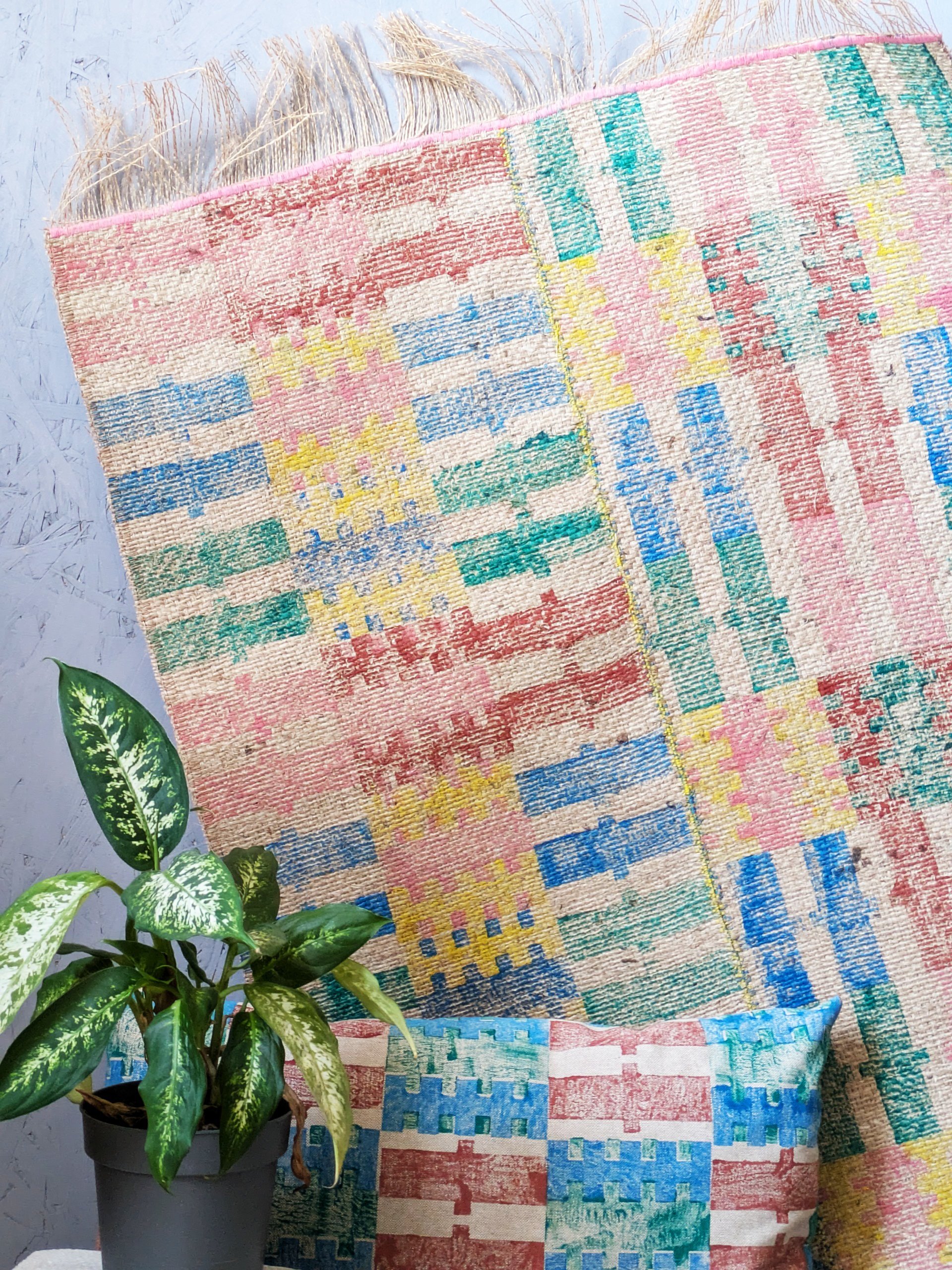 pattern play on jute rug with bold and pastel colourful stripes stitched together