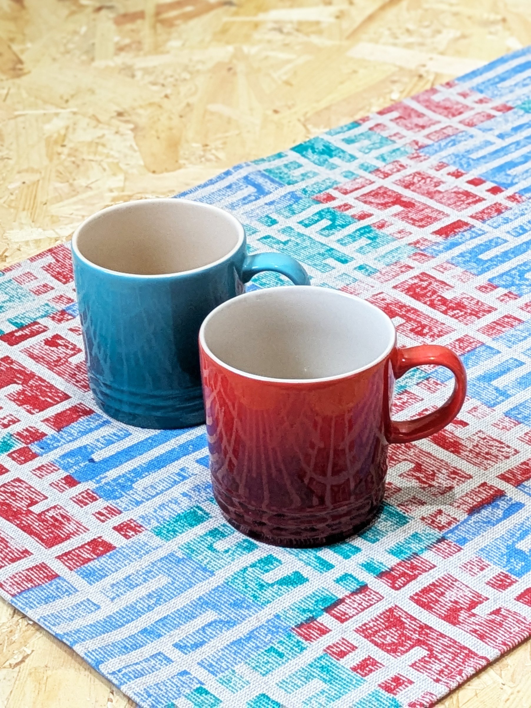 architecture inspired kitchen towel with teal and reg mugs