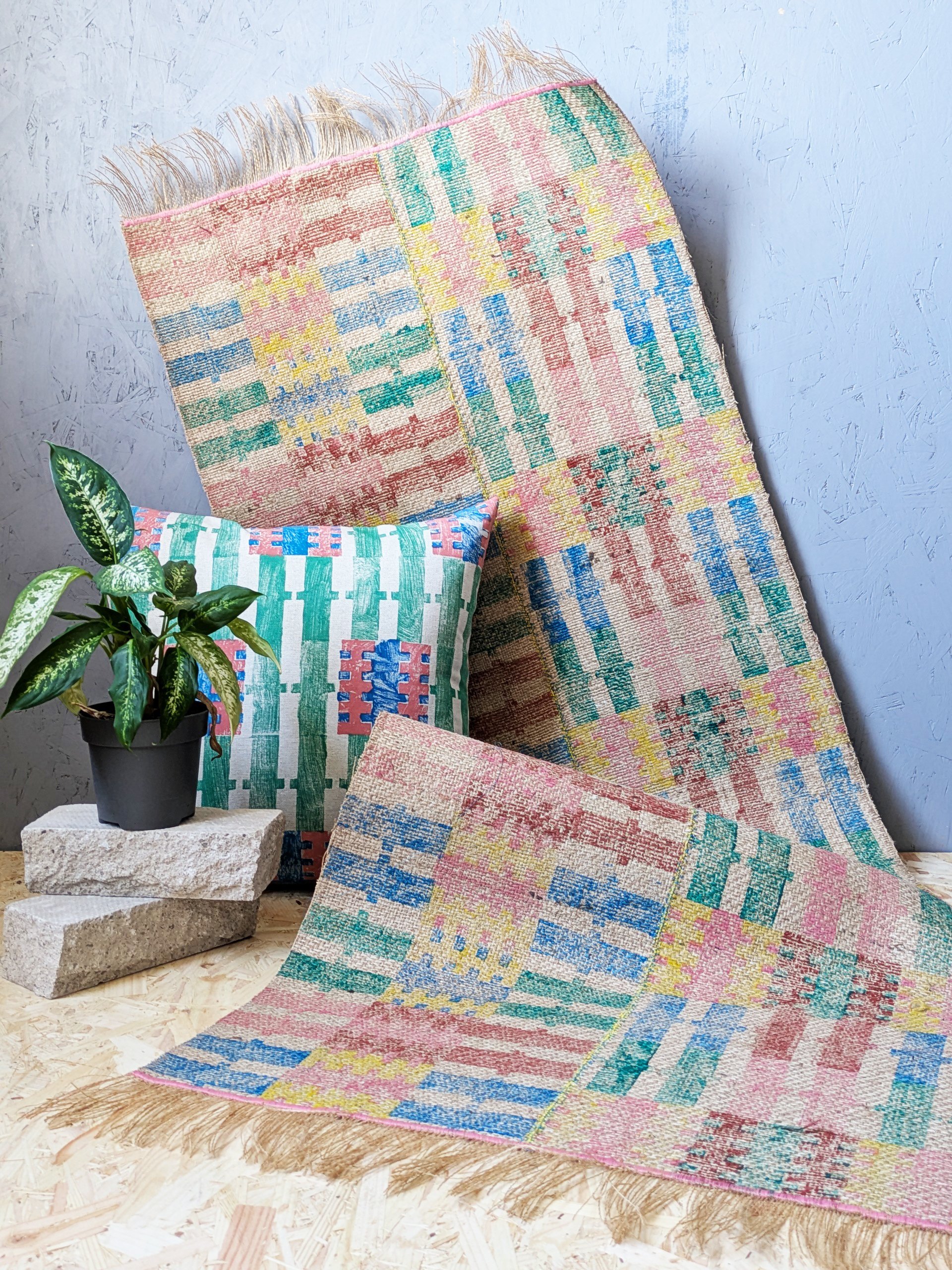 studio scene with bold, summery statement stripes on rug and cushion