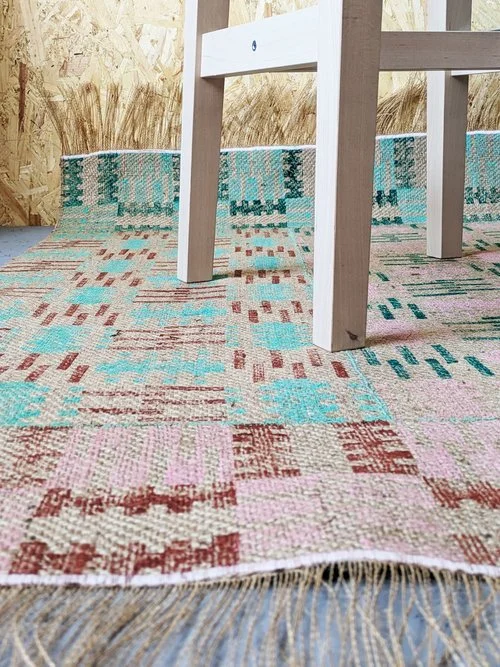 textured jute rug with pastel pink and green geometric chess pattern inspired by brutalist architecture