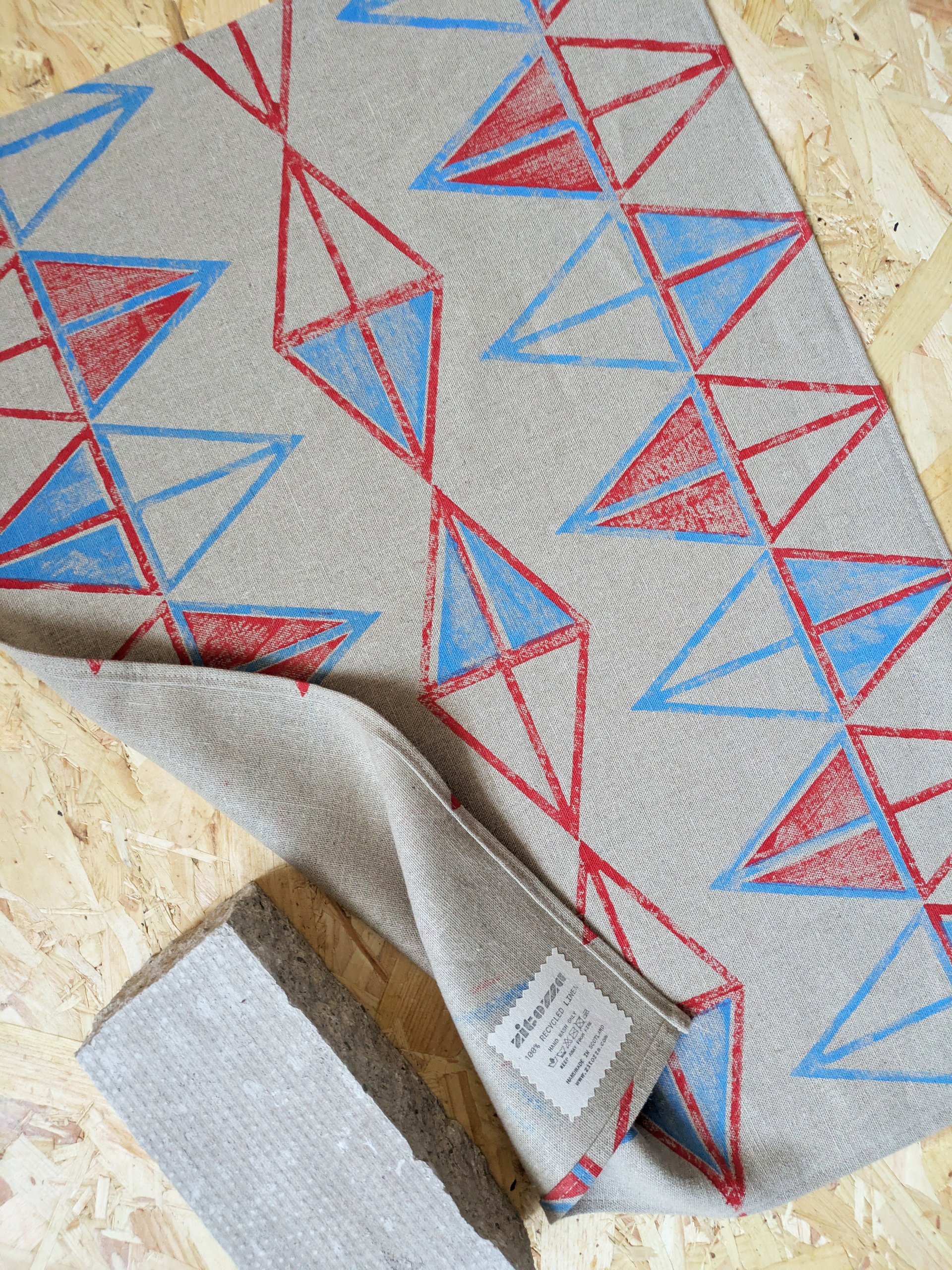 red and blue triangular abstract, geometric, mid-century modernism inspired print on recycled linen teatowel