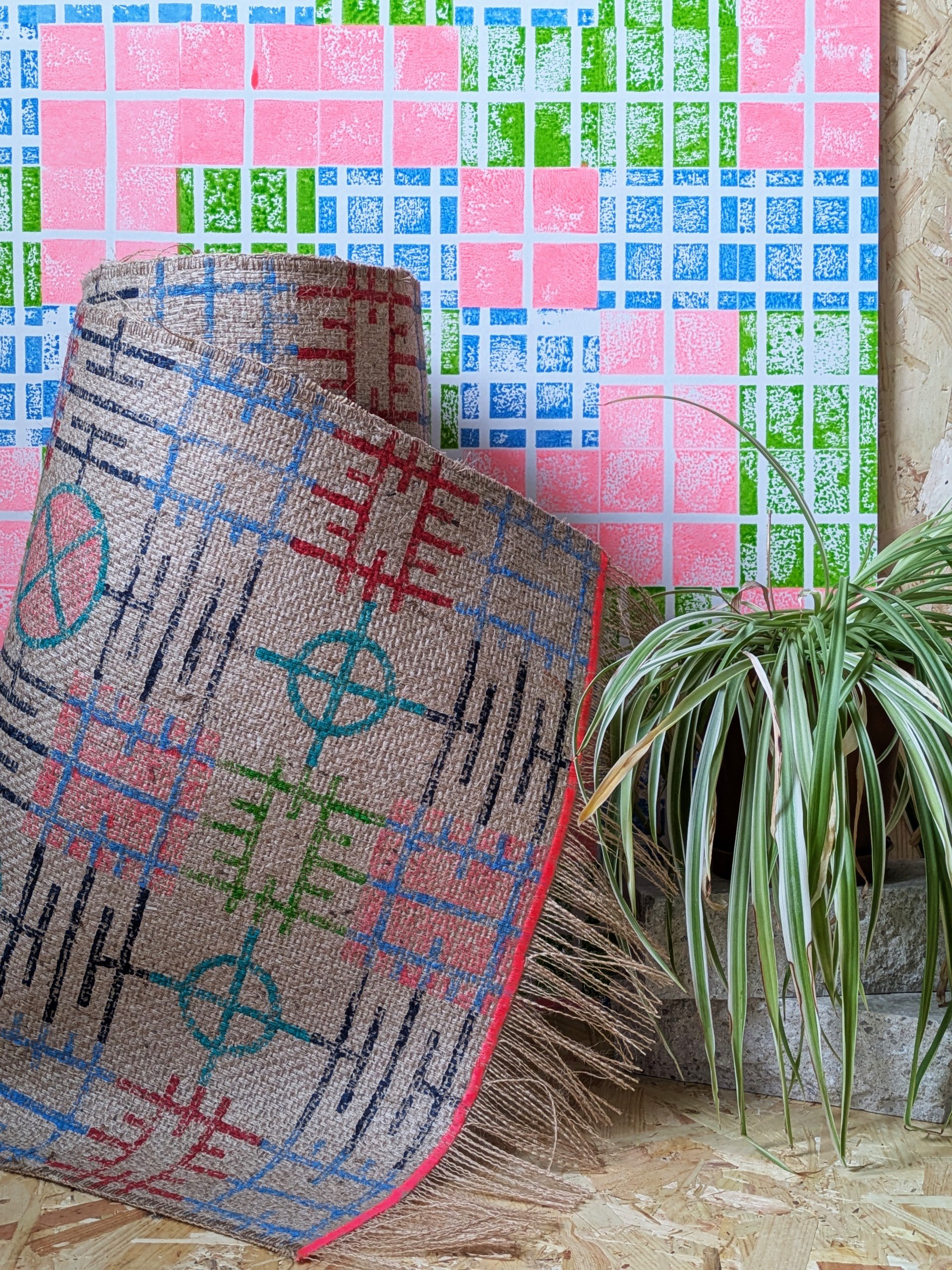 block printed jute runner in contemporary geometric pattern in bright studio with neon wallpaper