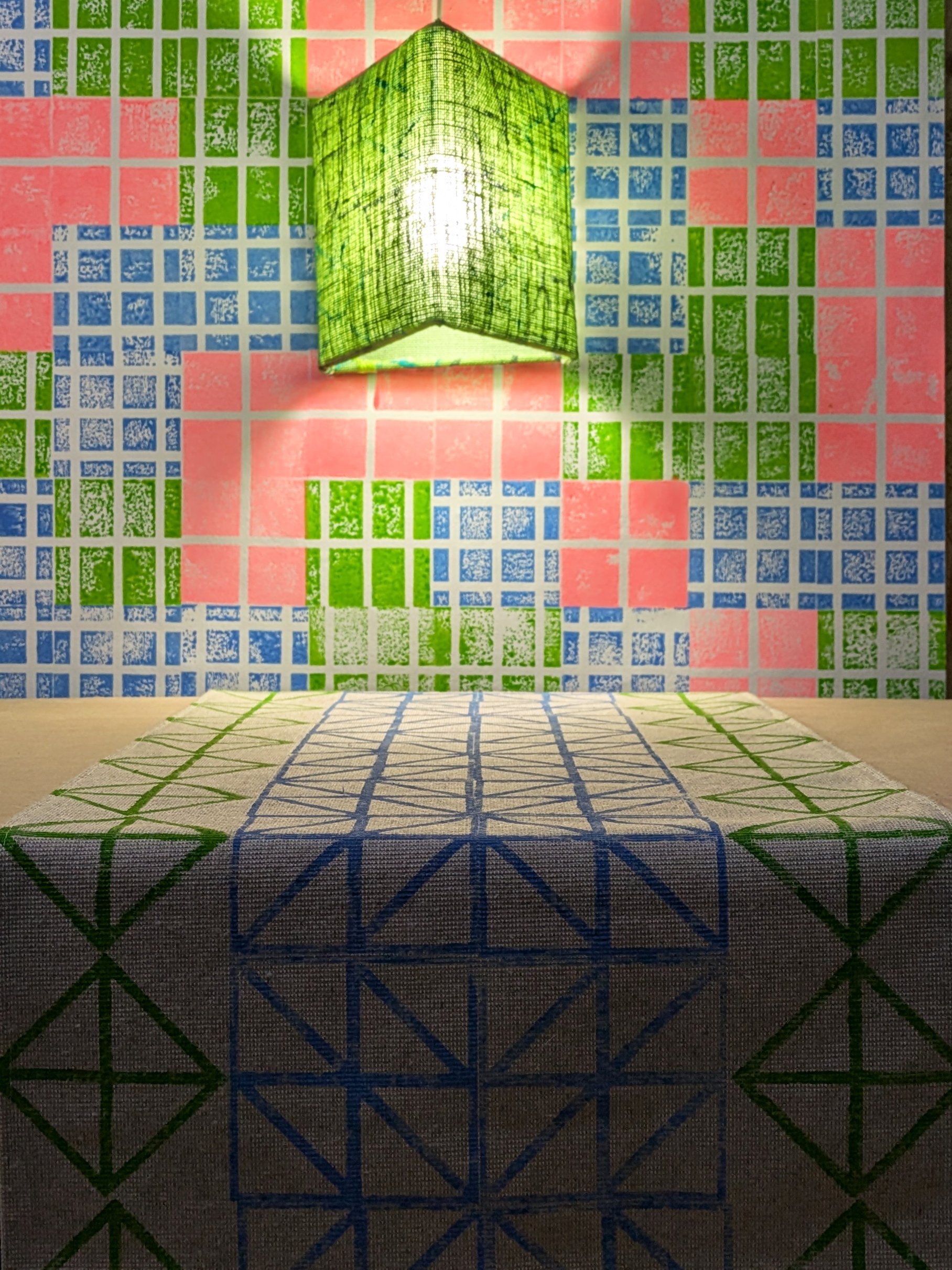 table runner on bright lit up desk with neon green and blue triangular pattern