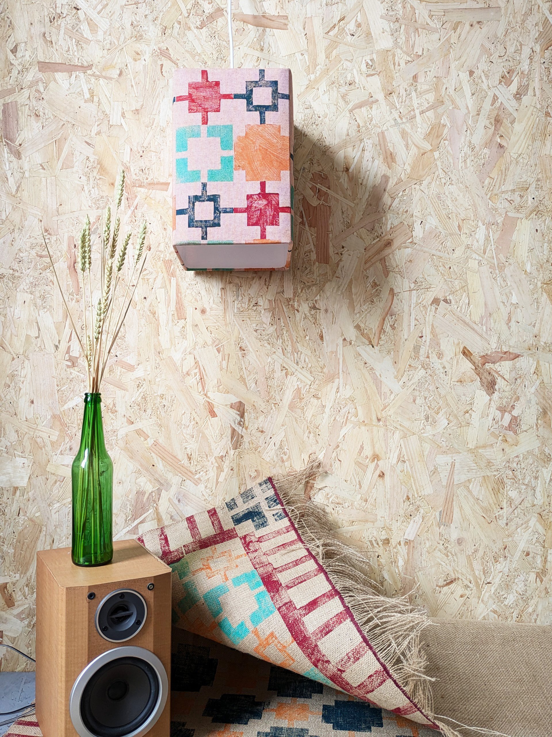 fun square print design on orange square lampshade in cosy boho interior