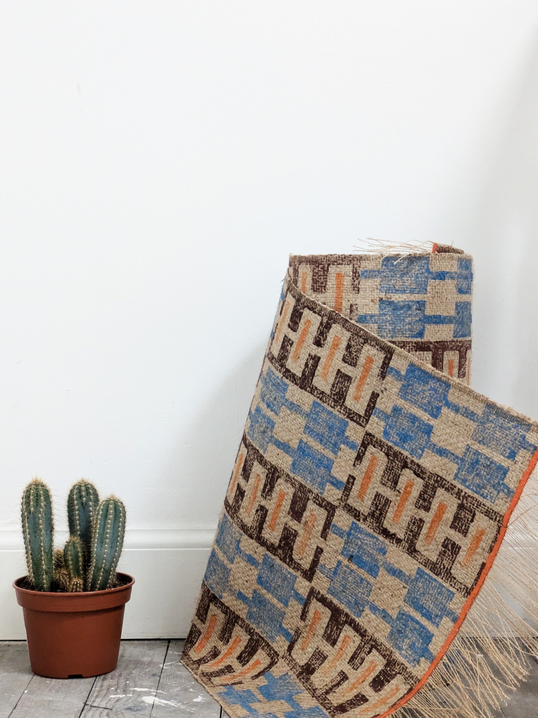 rolled up irunner rug with geometric hand block printed pattern on sustainable jute