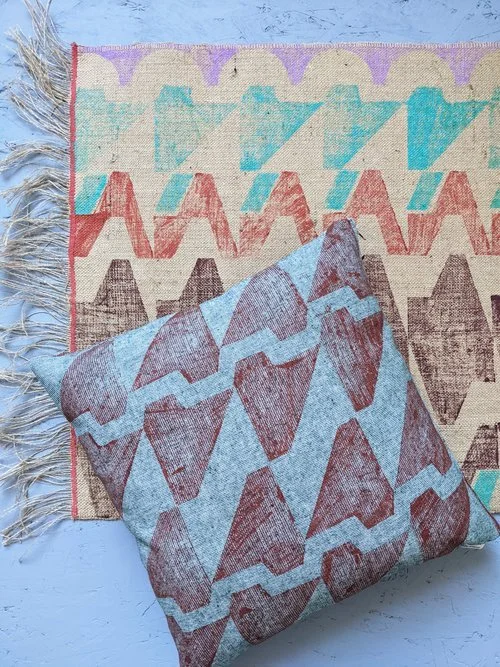 rug and cushion on floor with brutalism inspired abstract geometric modern patterns