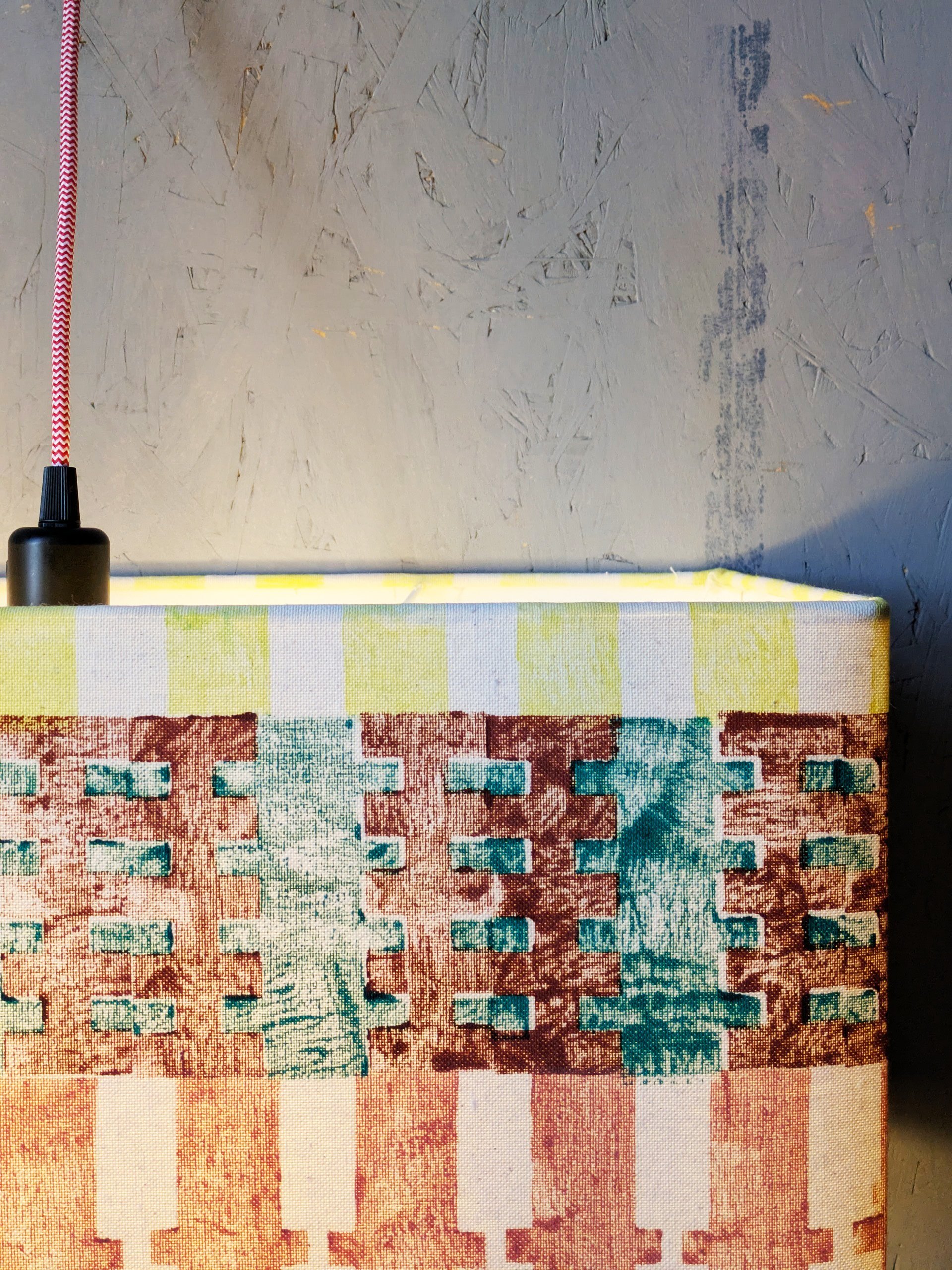 close-up detail of hand block printed stripes on lampshade with summery pastel colours