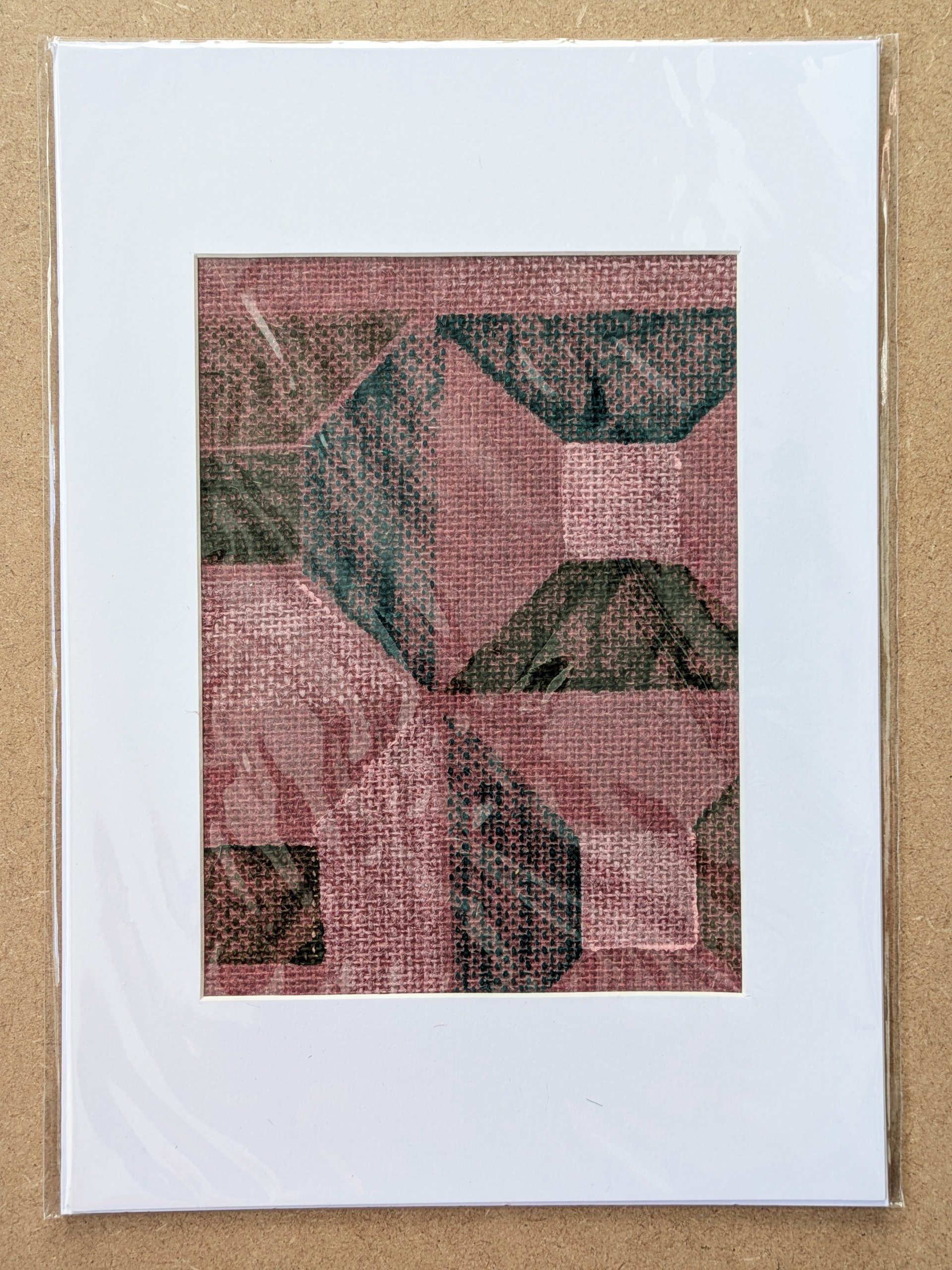 mounted A4 fabric art print with architecture inspired modern pattern in green colours hand block-printed on red grasscloth and framed in white mountboard