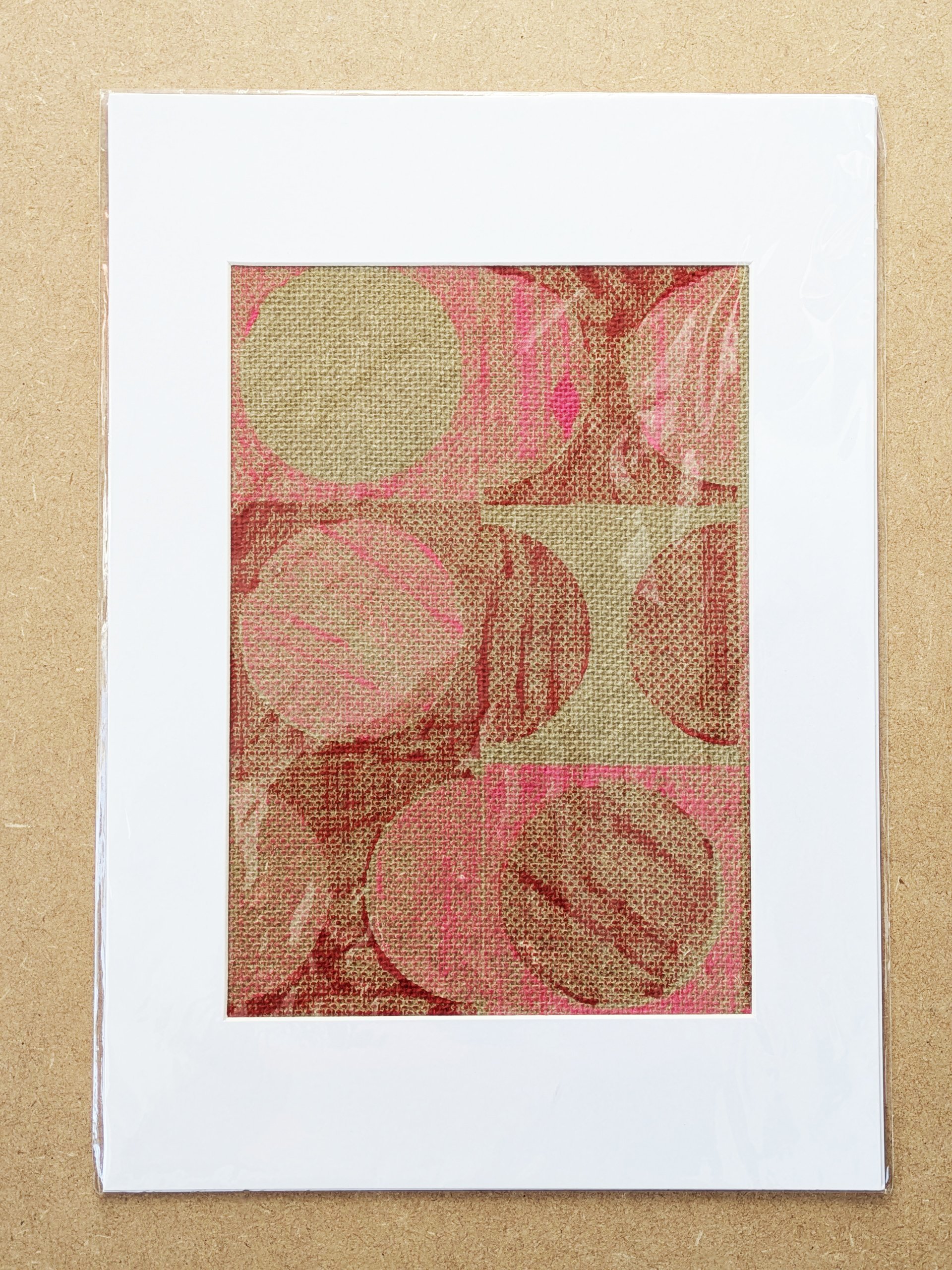 A3 modern abstract circular geometric print with in red and pink modern pattern hand block-printed on jute grasscloth and framed in white mountboard
