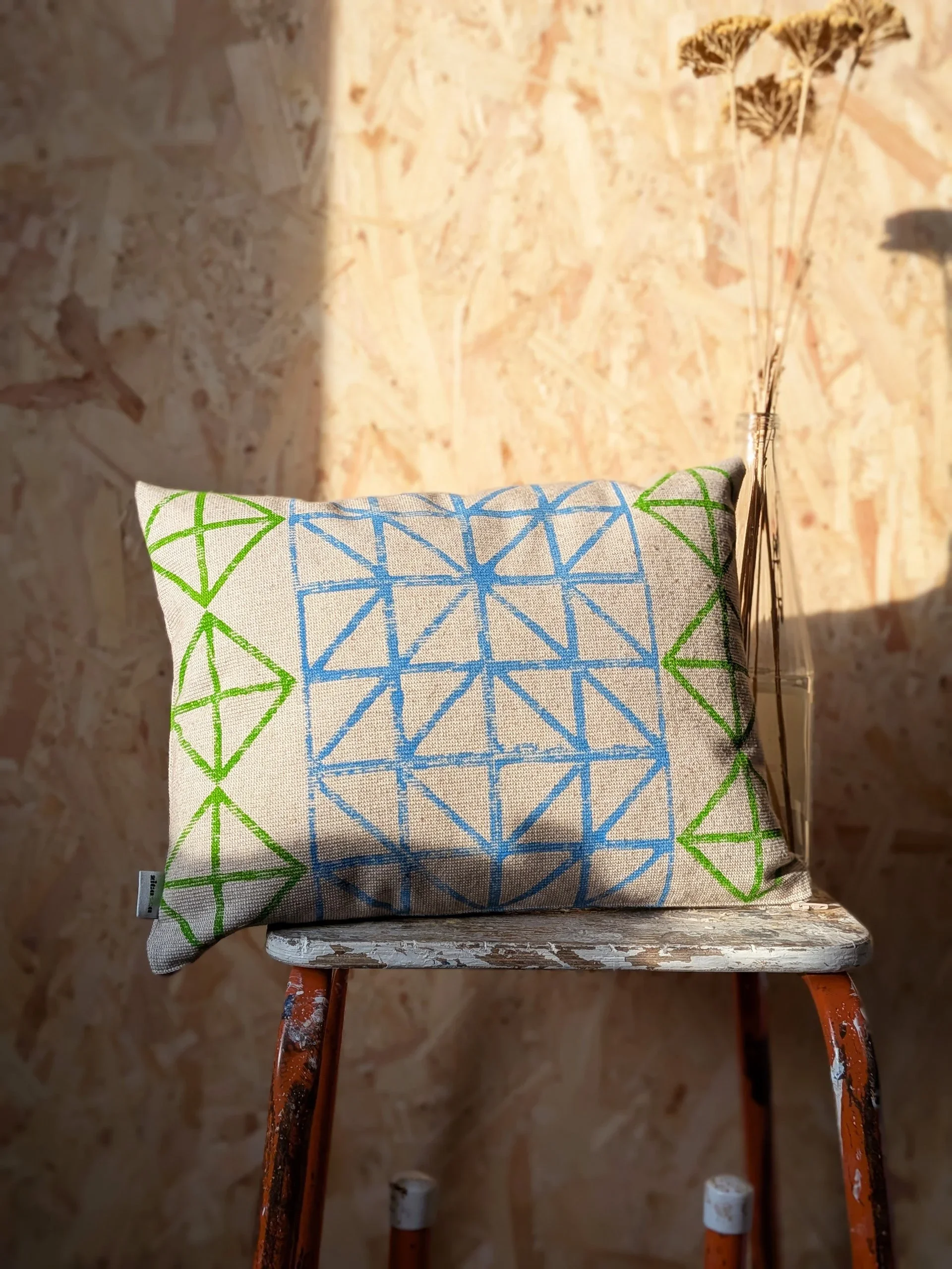 small cushion in sunny interior with grid block printed pattern