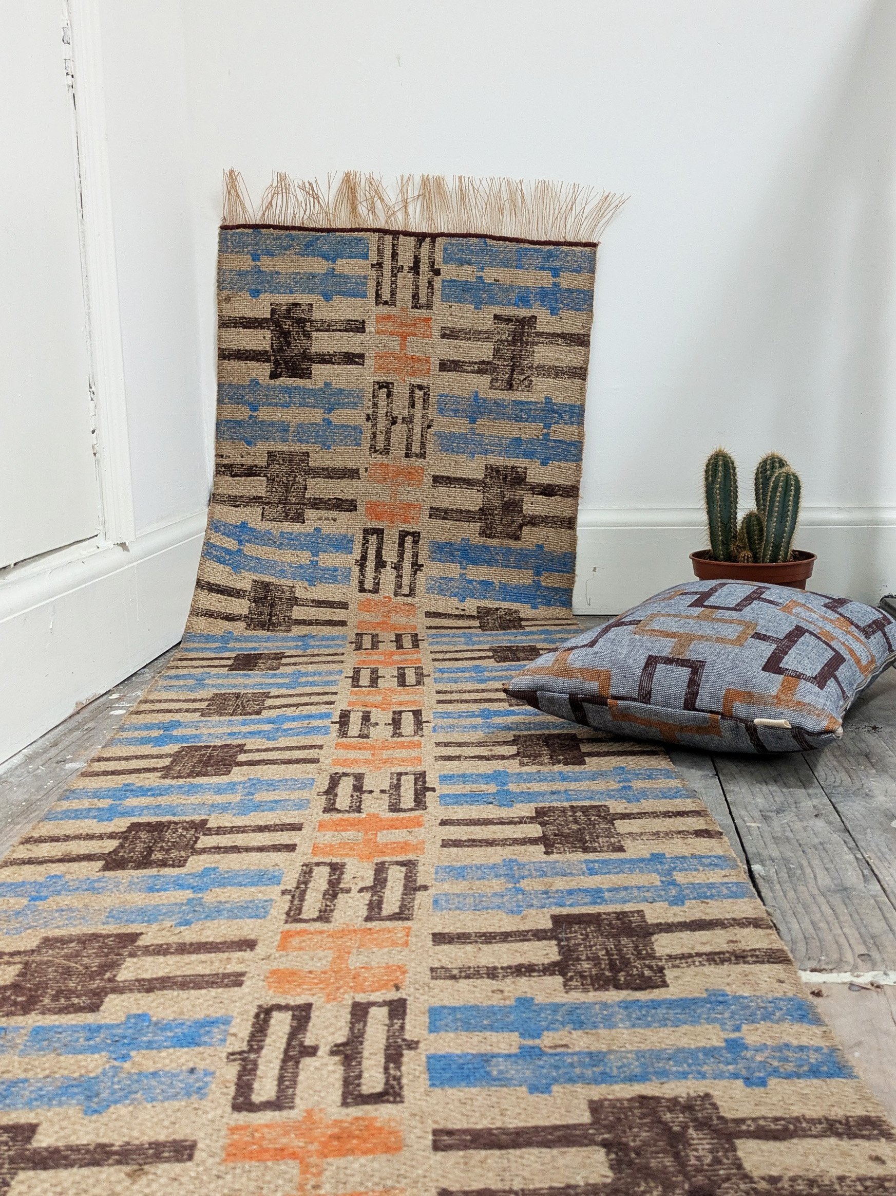 boho interior design scene with modern rustic rug in warm colours and cushion