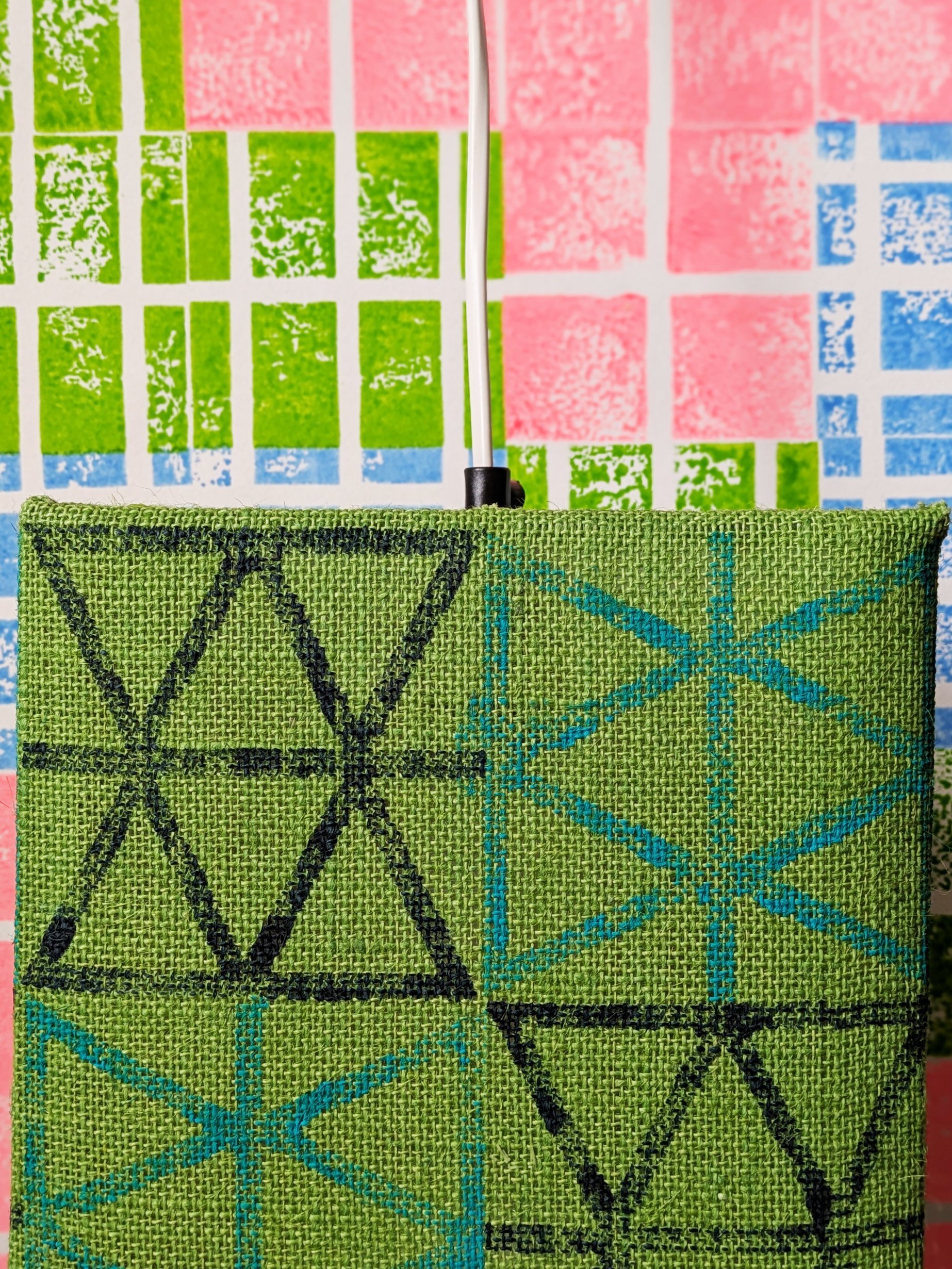 bright green lampshade with triangle print in close-up detail on bright green jute