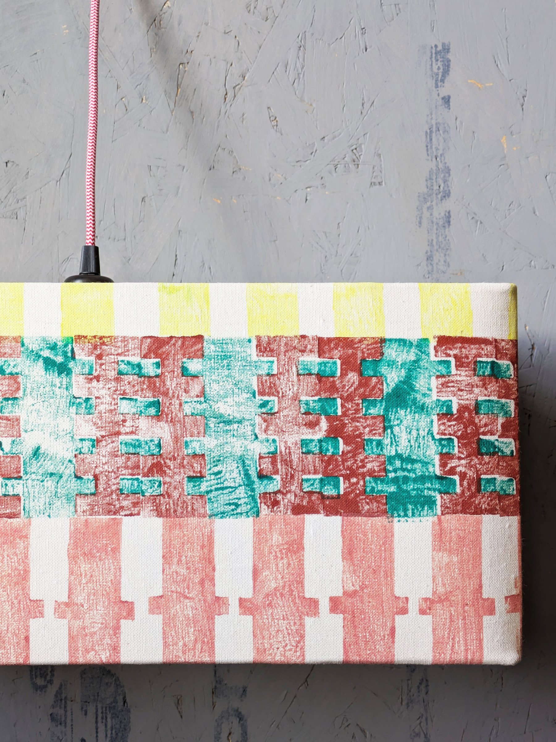 close-up detail of hand block printed pattern on lampshade in pastel pink and yellow striped summer lookbook