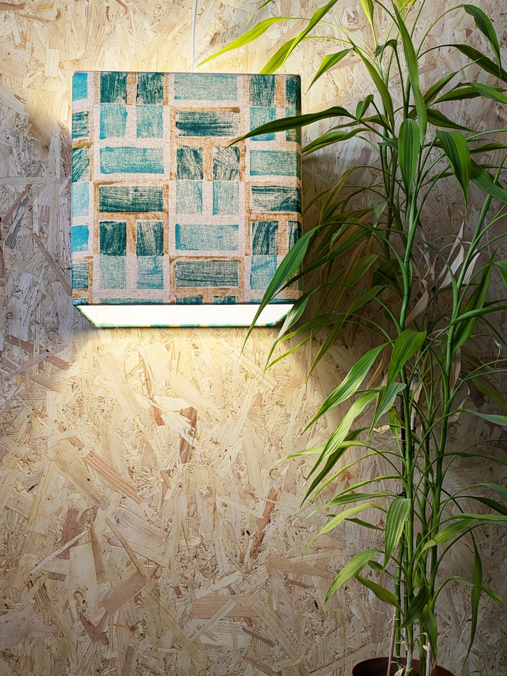 contemporary interior design scene with lush green lampshade in cube shape and geometric architectural print