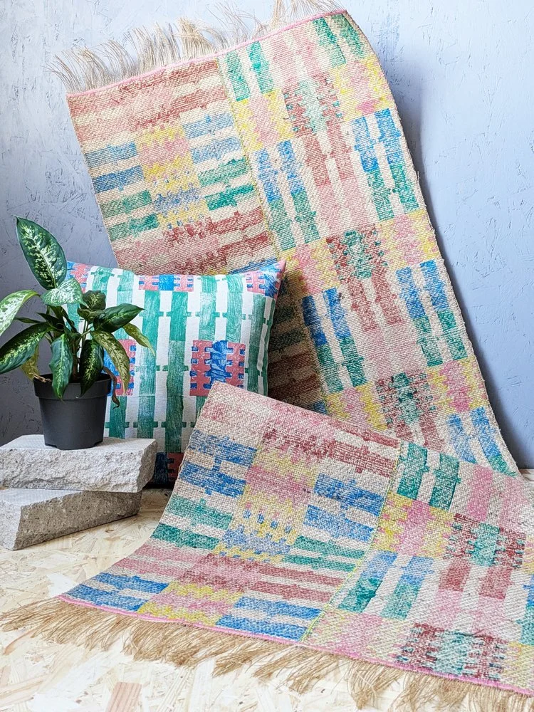 bright and bold asymmetrical rug with pastel printed stripes and matching bold striped cushion