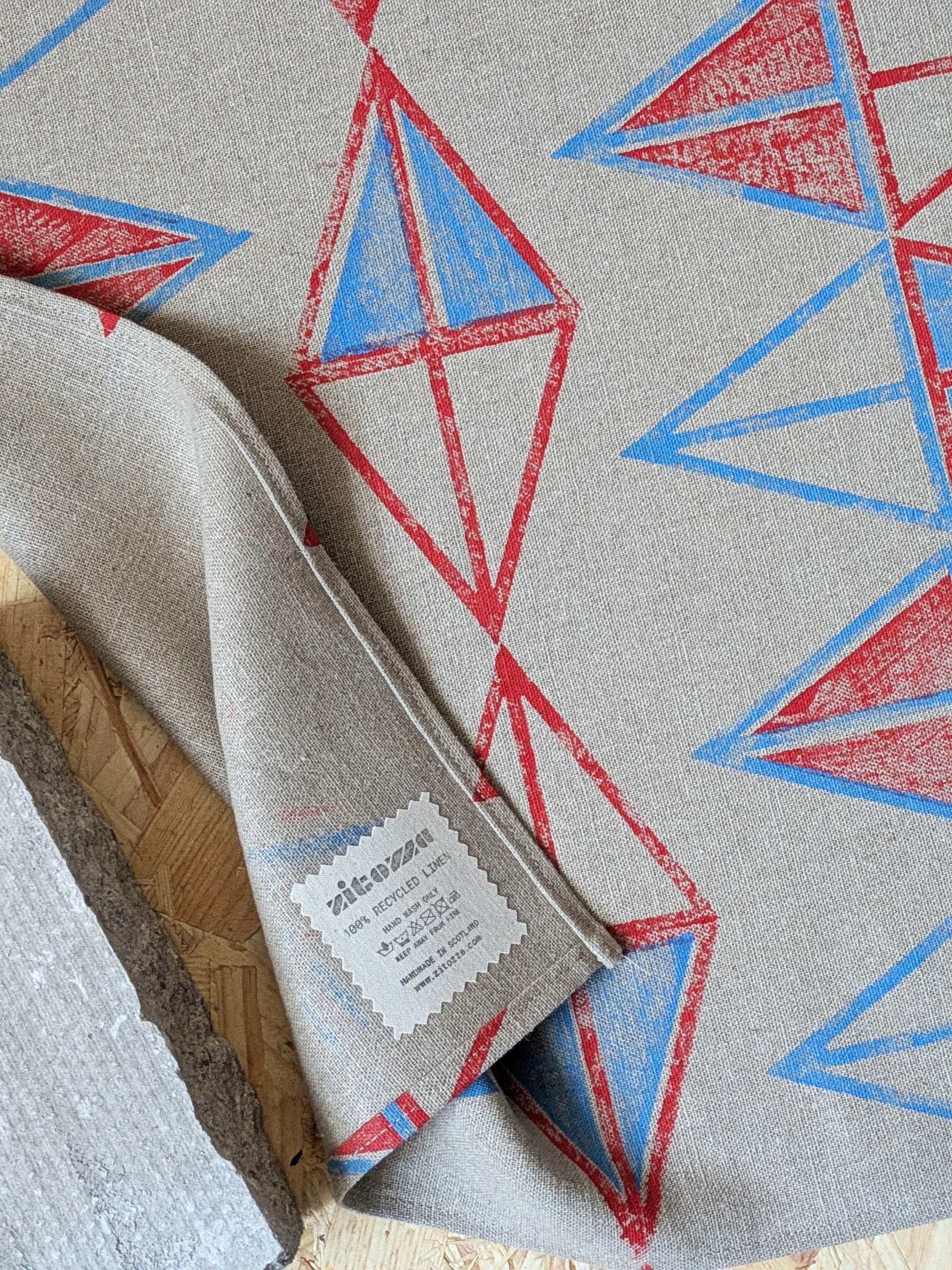close-up detail on hand block printed pattern triangular pattern on linen teatowel