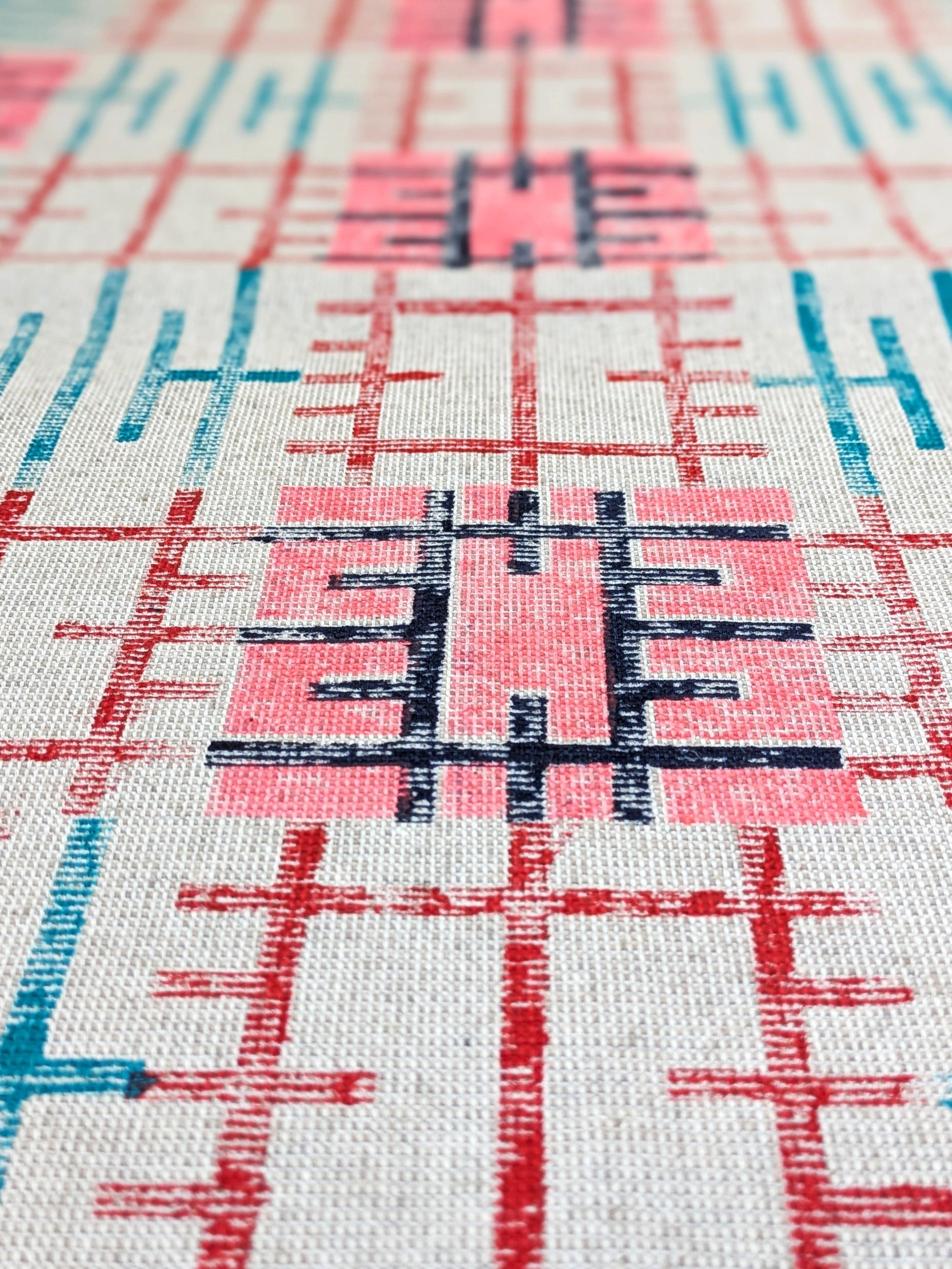 close-up detail of block printed grid pattern on teatowel