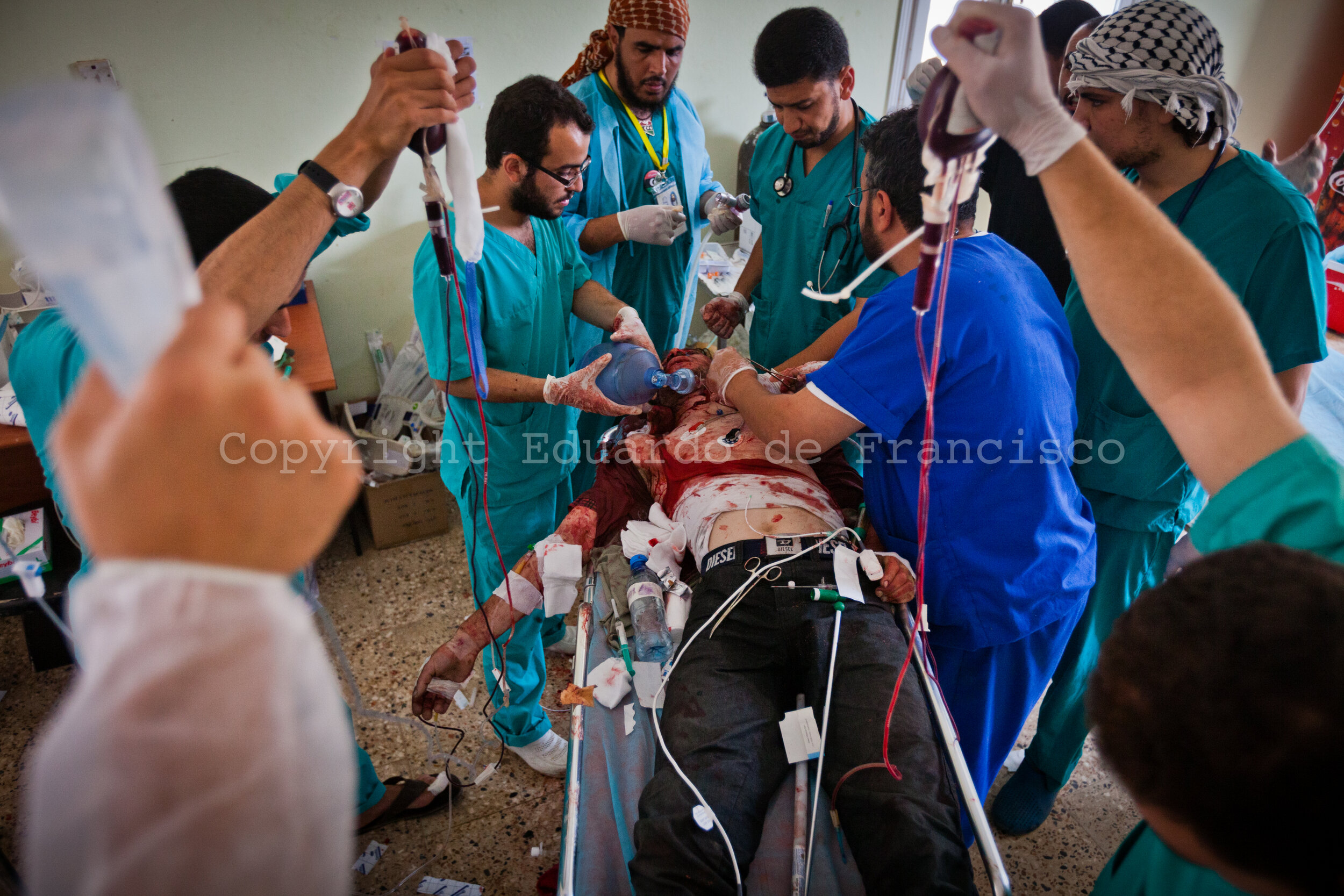  At a field hospital in the Ad Dafiniyah frontline west of Misrata, a group of doctors tries to save the life of a soldier freshly injured. In spite of the medical team's efforts, he lost his live 