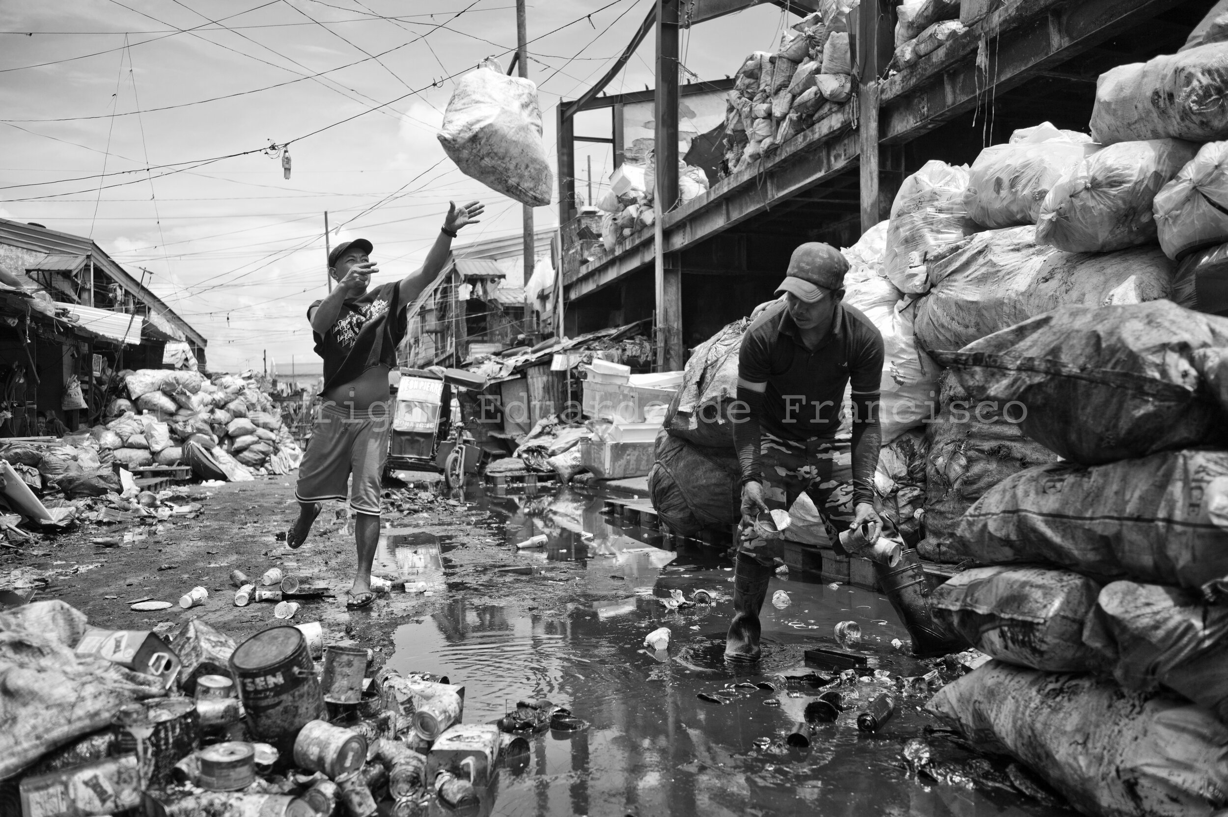  John Ocampo (right) and John De los Santos. They work together recycling rubbish in the streets of 'Aroma'. They have been in Manila since 31 and 40 years ago, respectively. 
